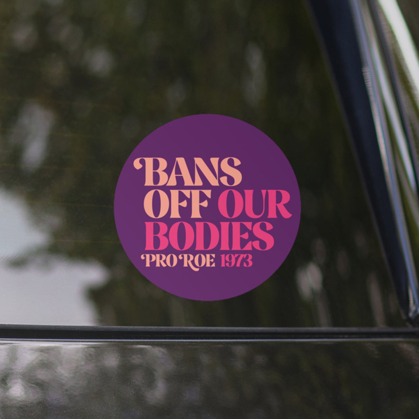 Close-up of the bold Bans Off Our Bodies slogan sticker on a car