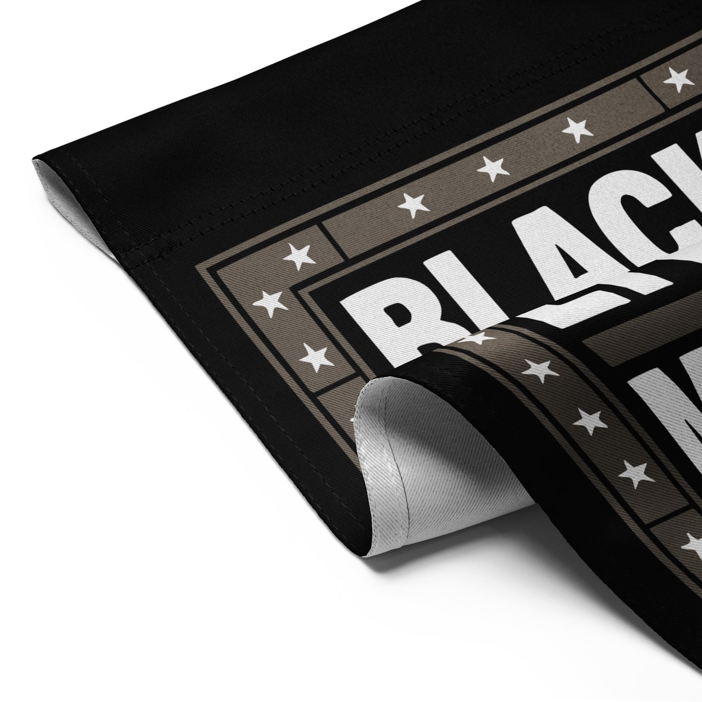 Detailed folded view of the Black Lives Matter garden flag with strong block lettering and star border.