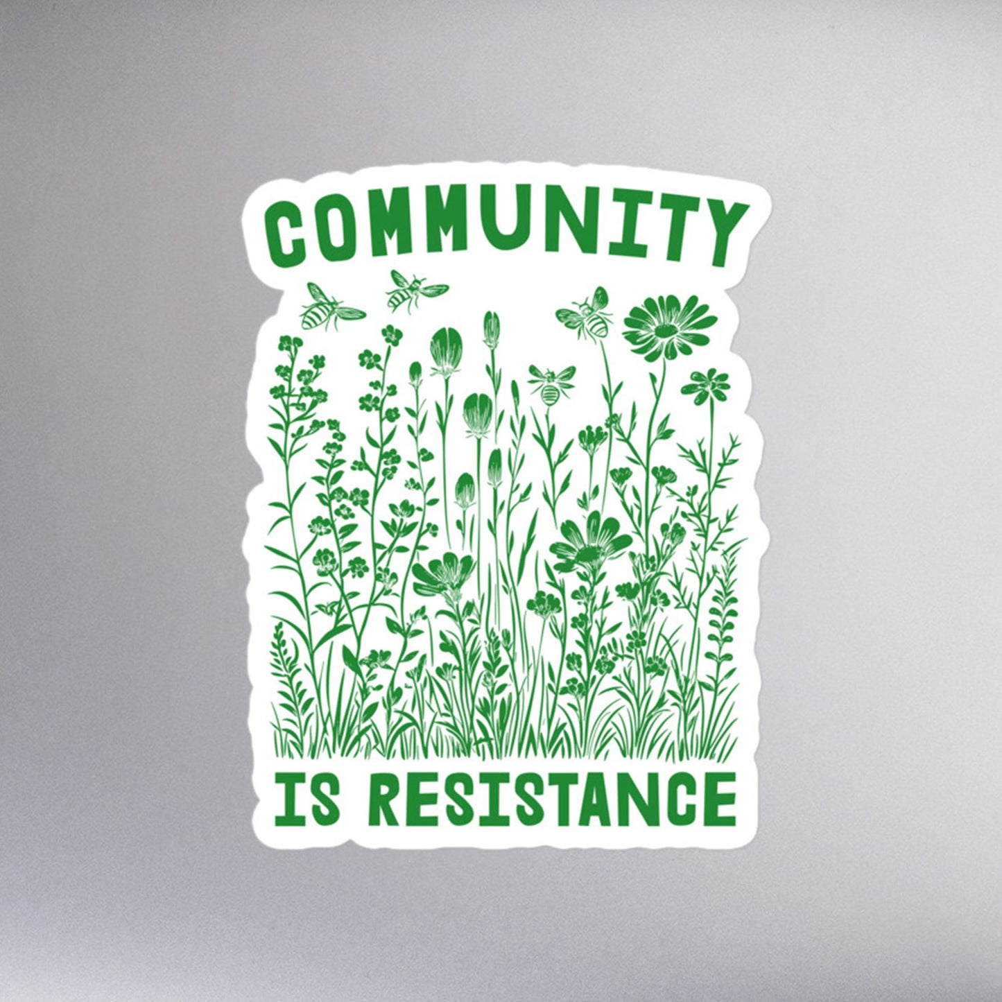 Close-up of the words "Community Is Resistance" on the sticker.