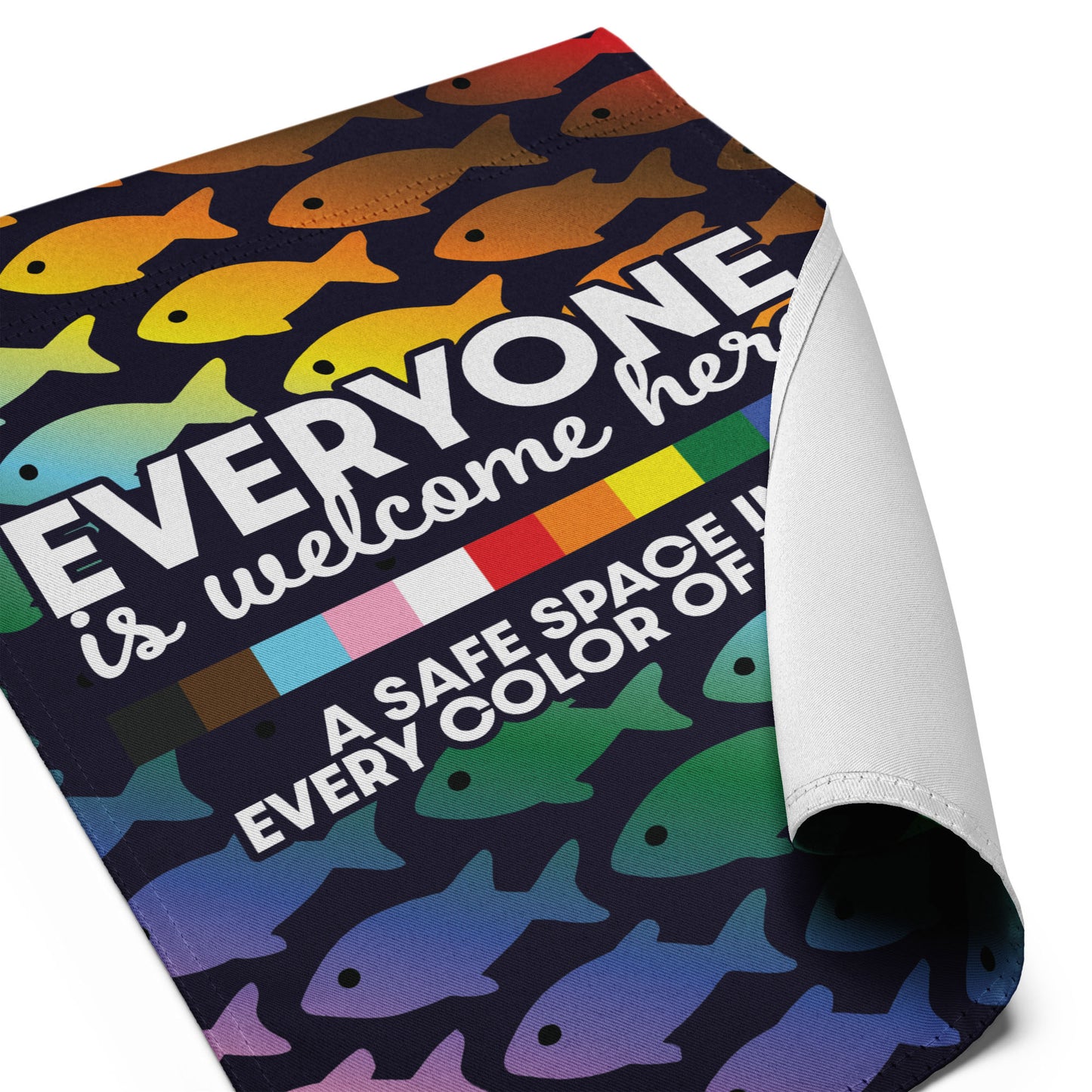 Detailed angled view of the “Everyone Is Welcome Here” inclusive pride garden flag with folded fabric corner.