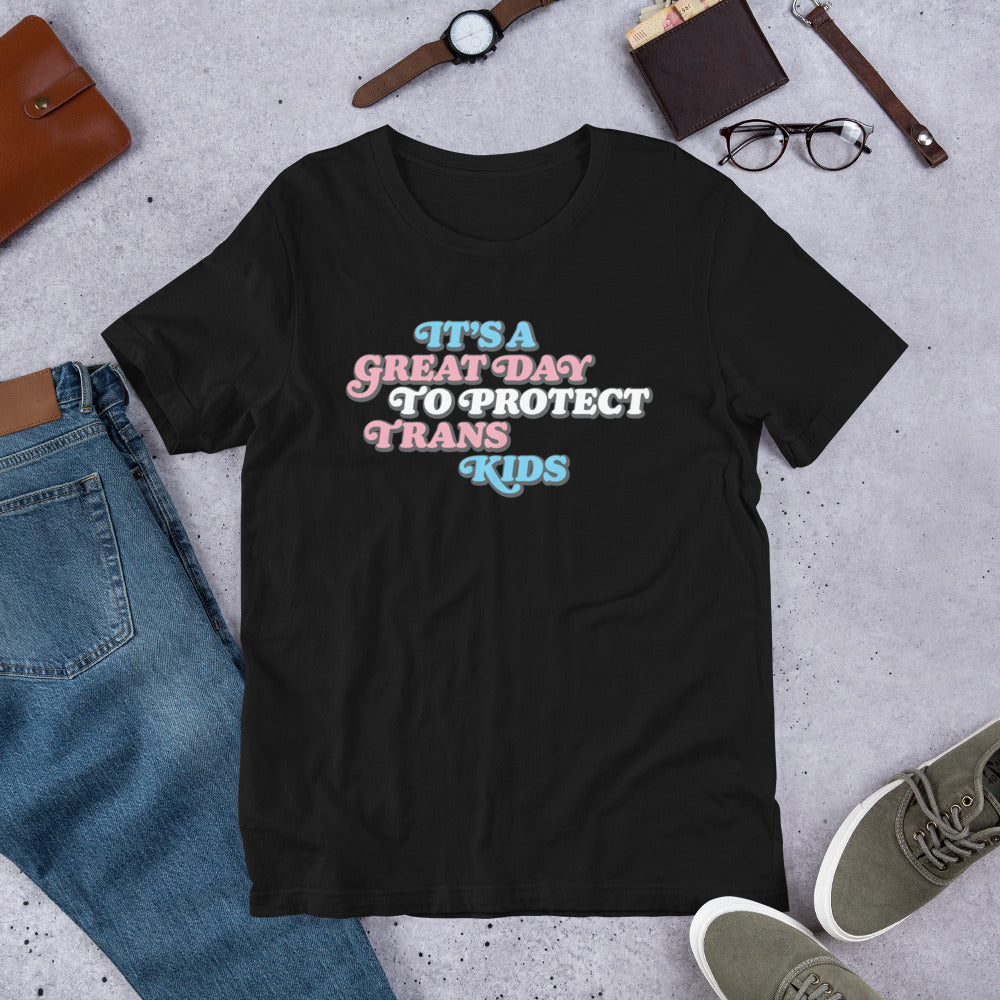 Flat lay of It’s A Great Day To Protect Trans Kids Unisex T-Shirt