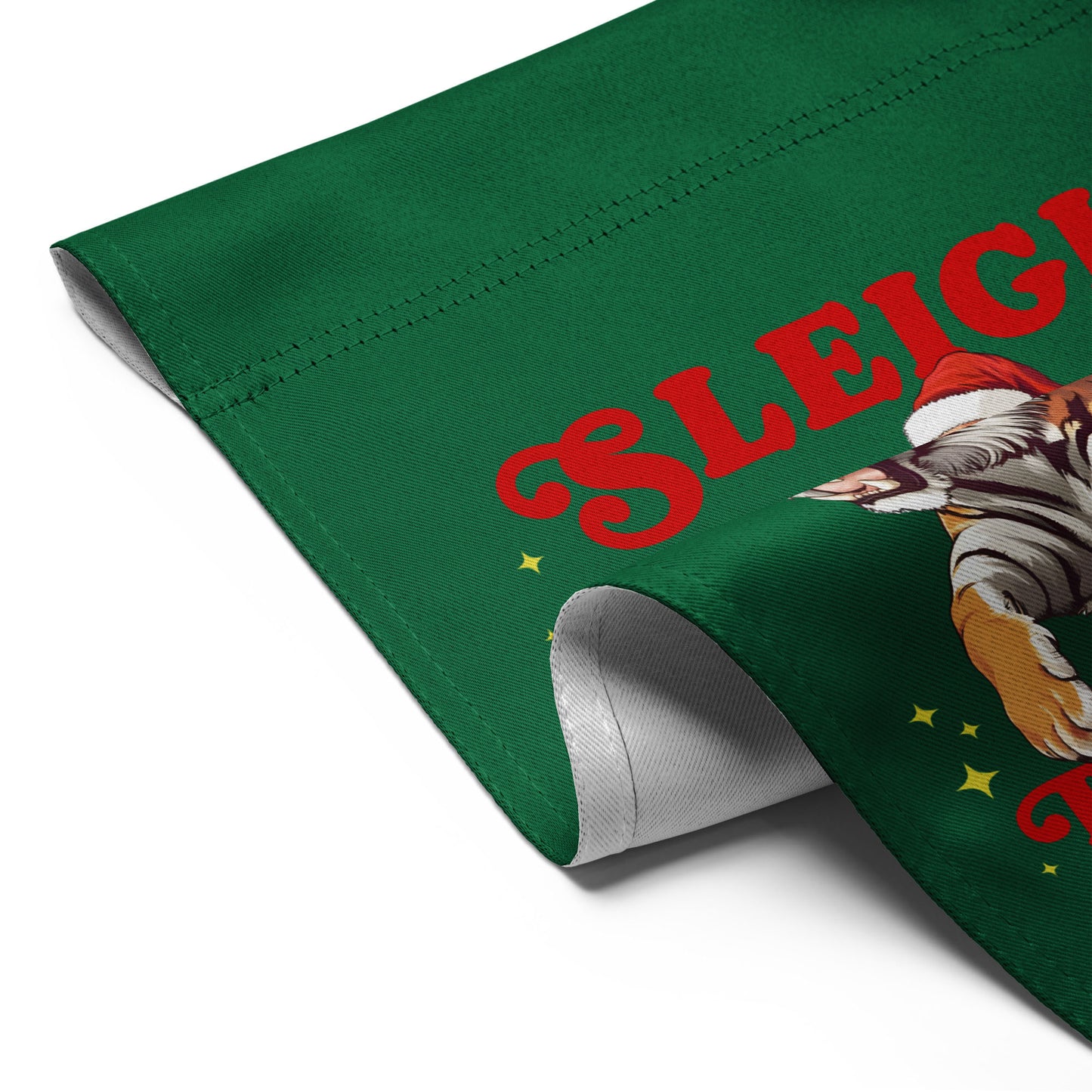 Angled view of the “Sleigh the Patriarchy” Christmas garden flag with folded corner showing festive print details.