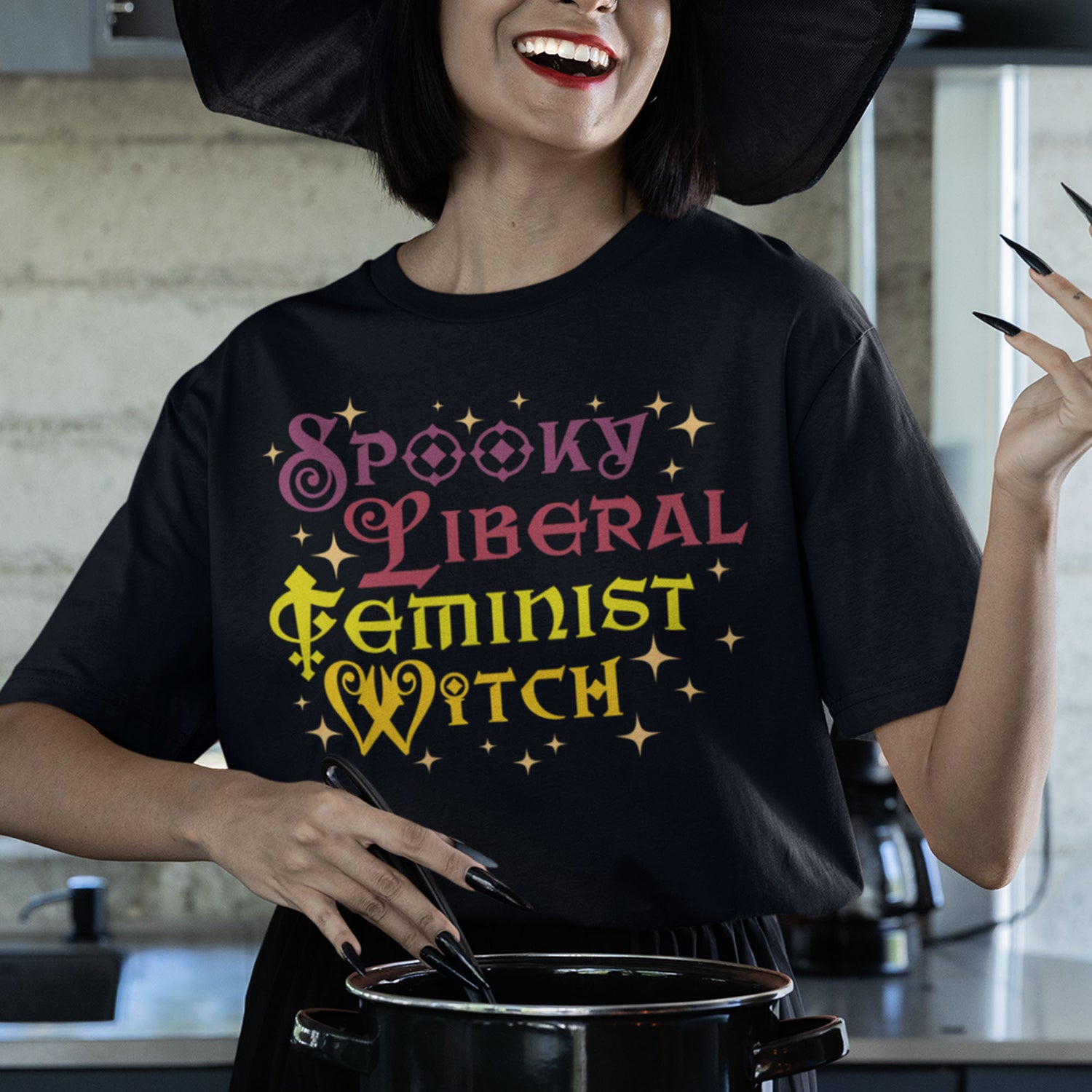 Smiling woman wearing “Spooky Liberal Feminist Witch” Halloween shirt with sparkly lettering, activist feminist fashion.