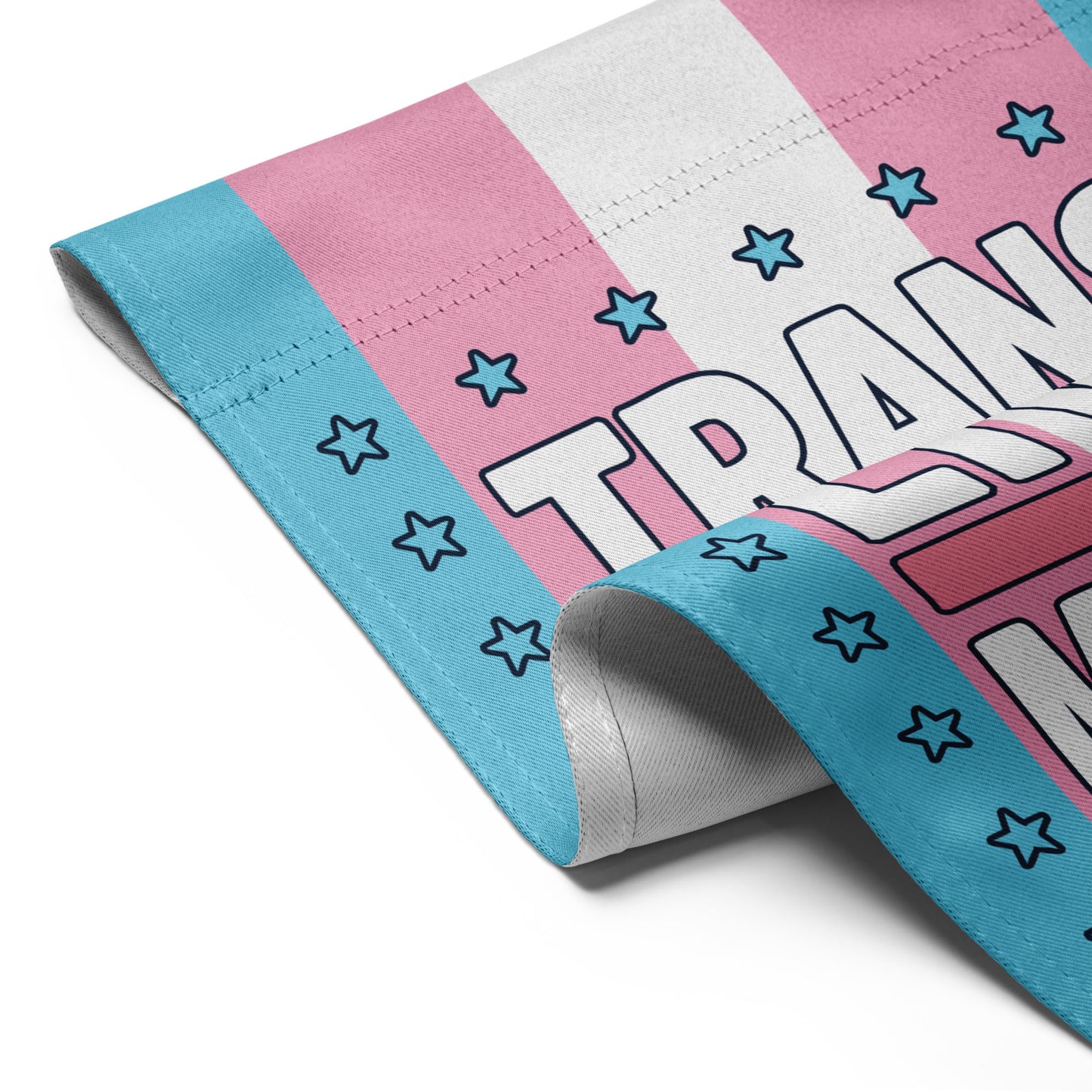 Close-up of Trans Lives Matter Progressive Garden Flag with stars and bold activist lettering