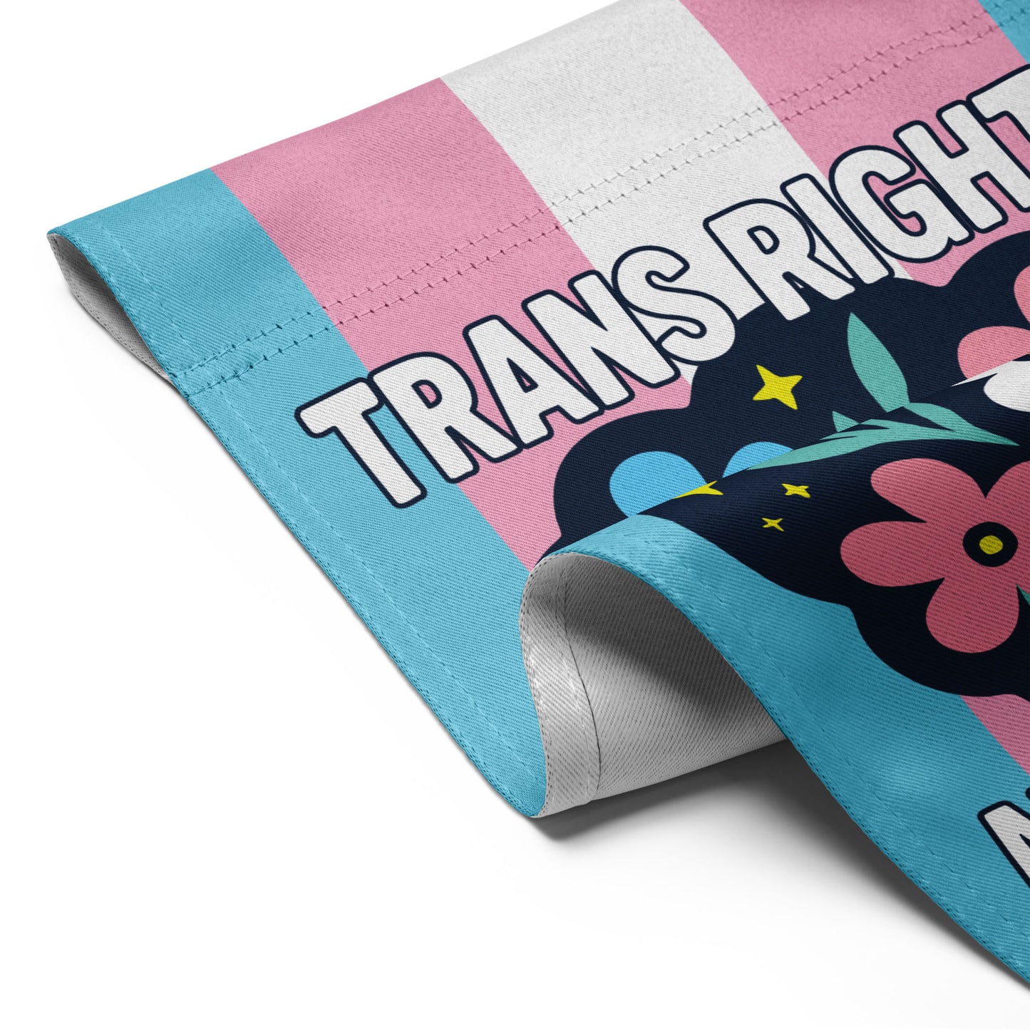 Detail view of the Trans Rights Are Human Rights Flag with floral illustration and activist message