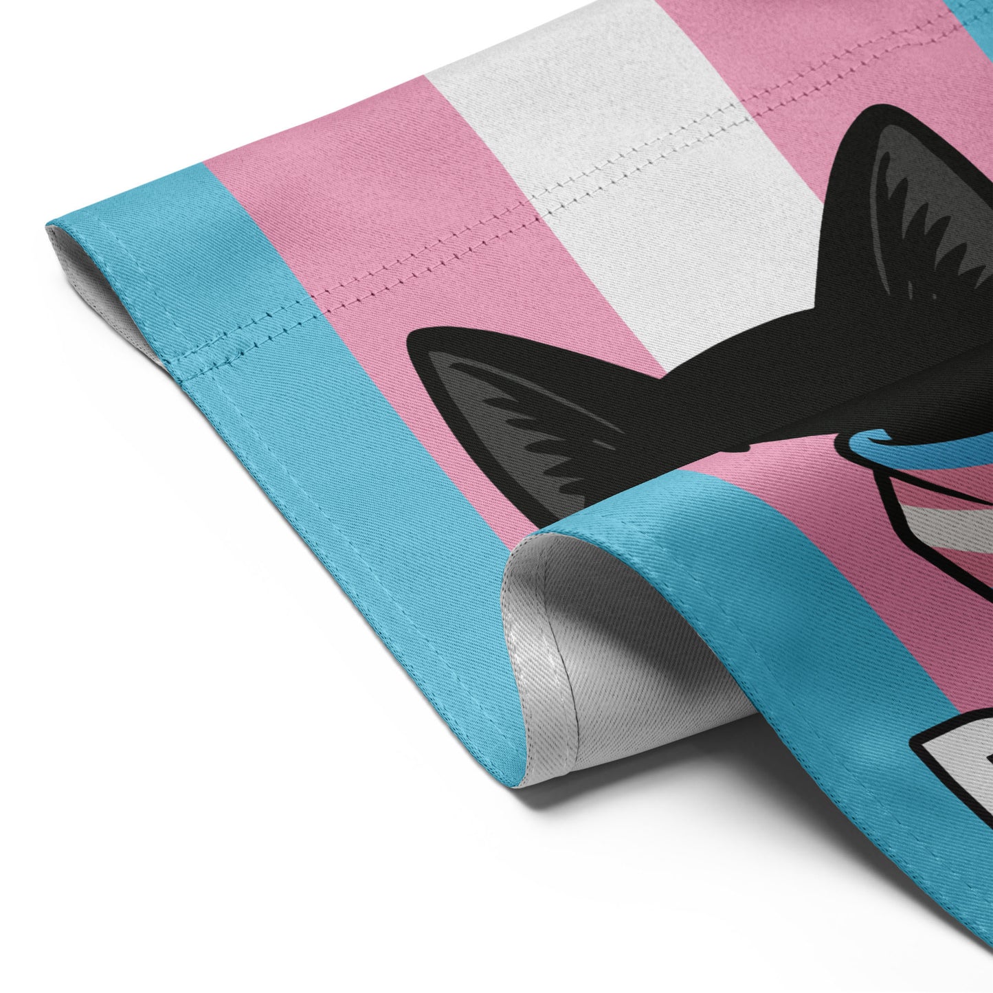 Detailed fabric view of the “Purride” cat garden flag with trans pride stripes and bold black cat illustration.