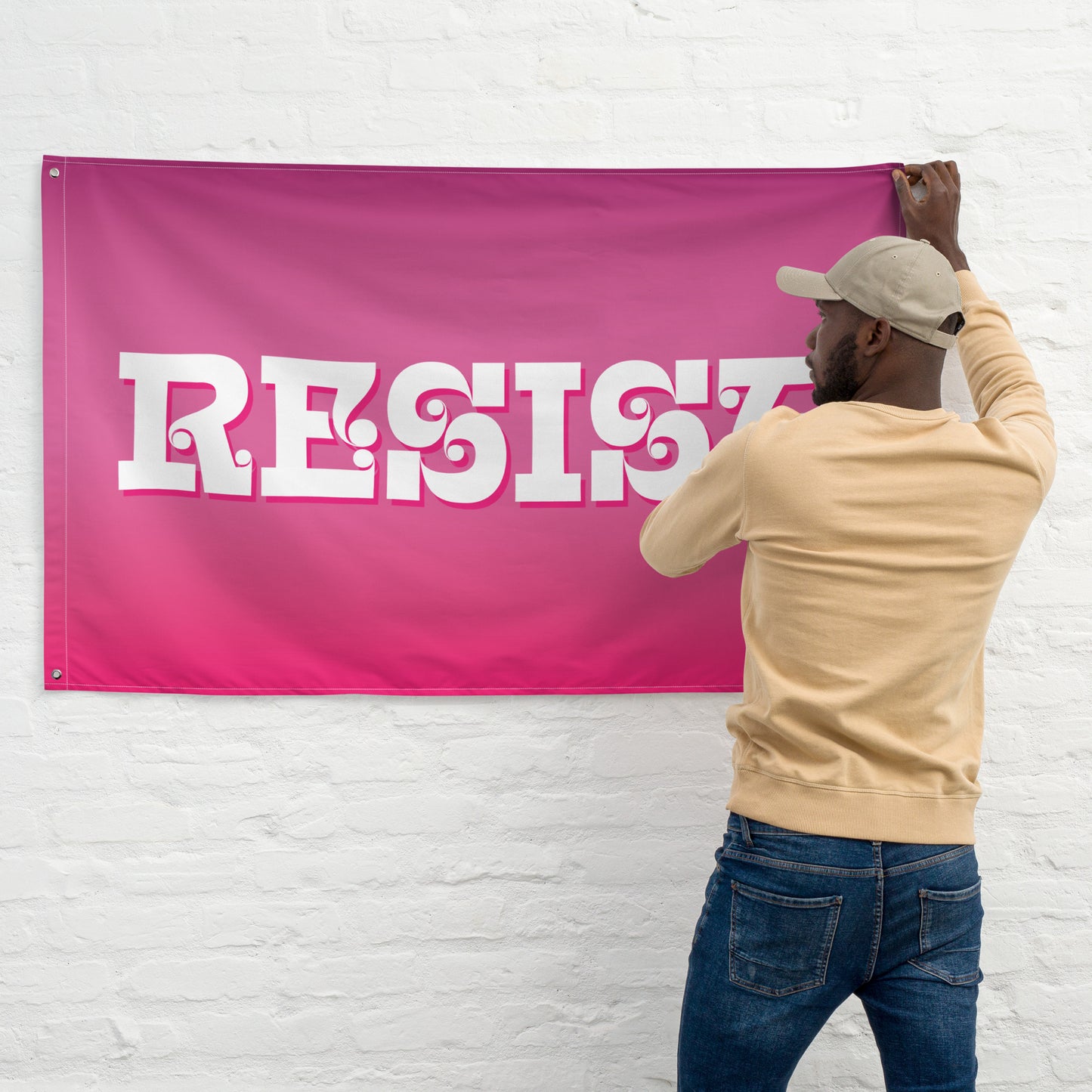 Person holding Bold RESIST Pink Feminist Flag.