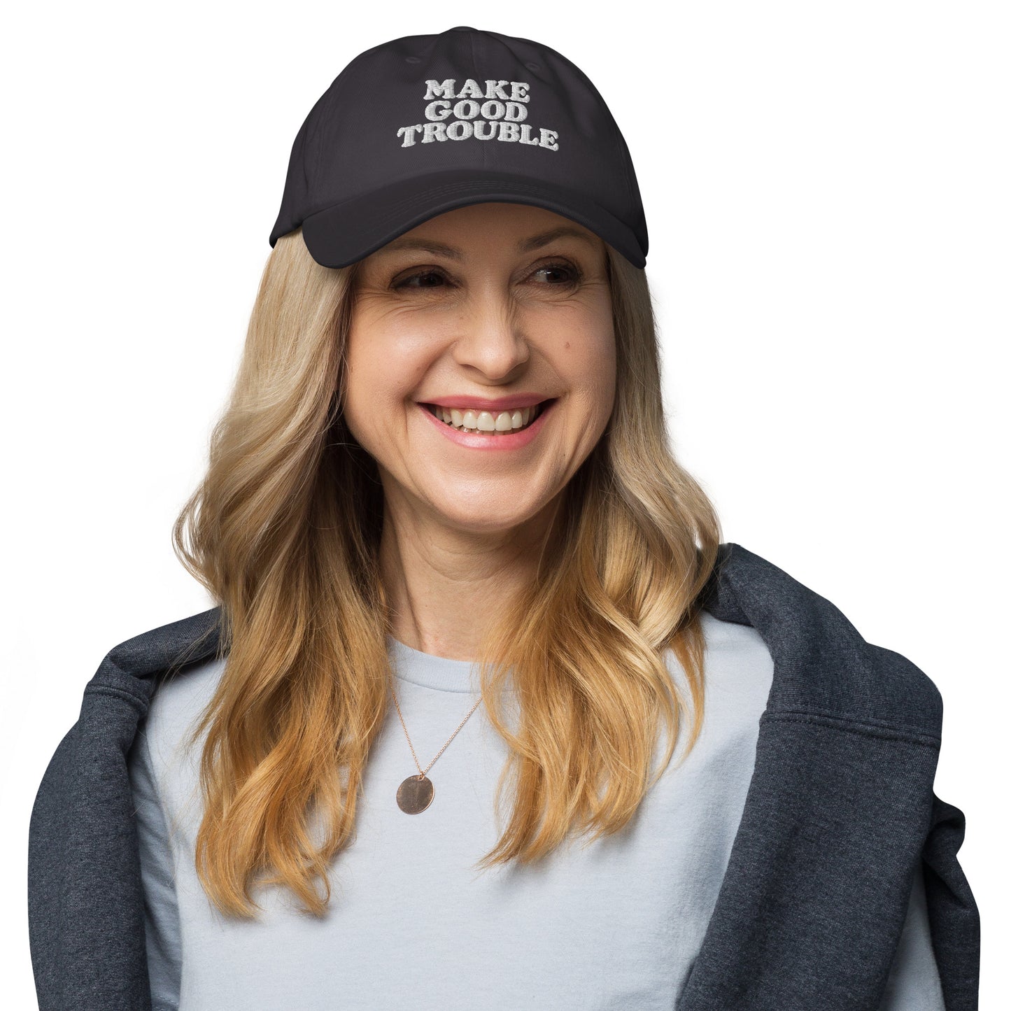 Female protester wearing the John Lewis "Make Good Trouble" Quote Social Justice Dad Hat