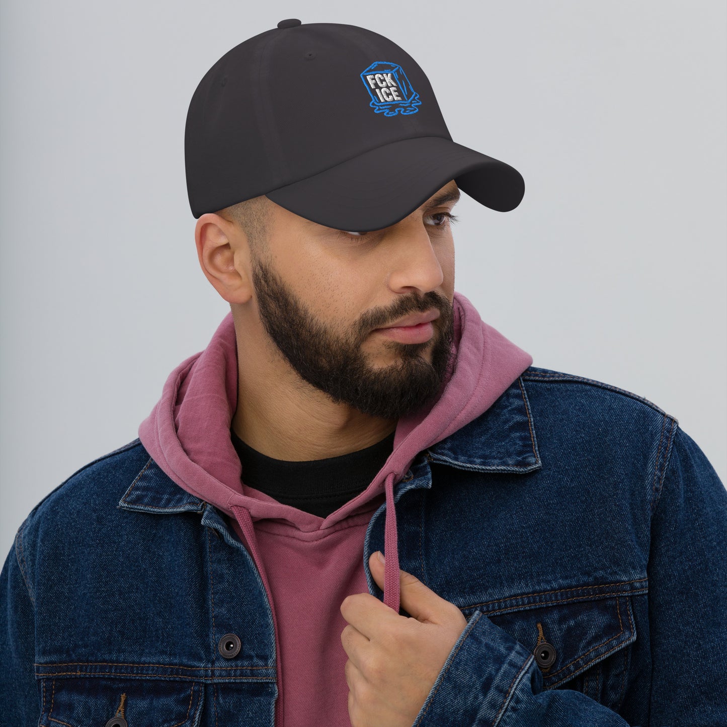 Lifestyle Image: Man wearing embroidered F*CK ICE melting cube graphic protest hat with abolitionist design