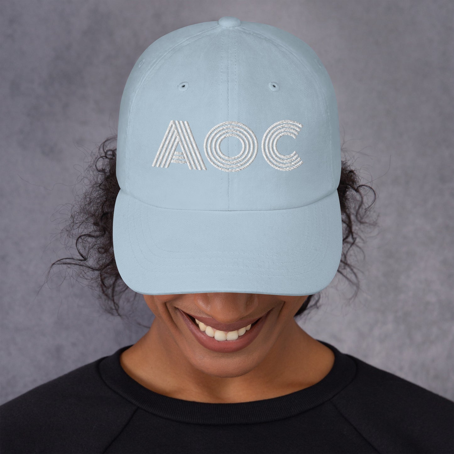 Lifestyle Image: Woman change-maker wearing the retro AOC hat
