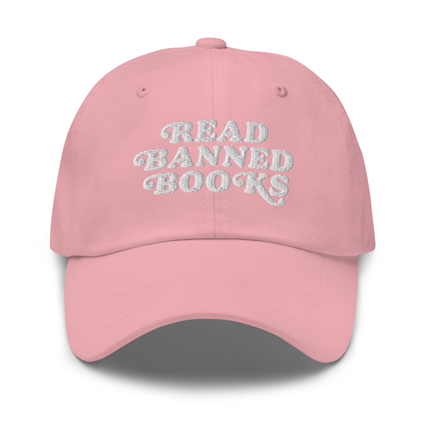 Pink embroidered dad hat displaying retro-style white lettering reading “READ BANNED BOOKS.”