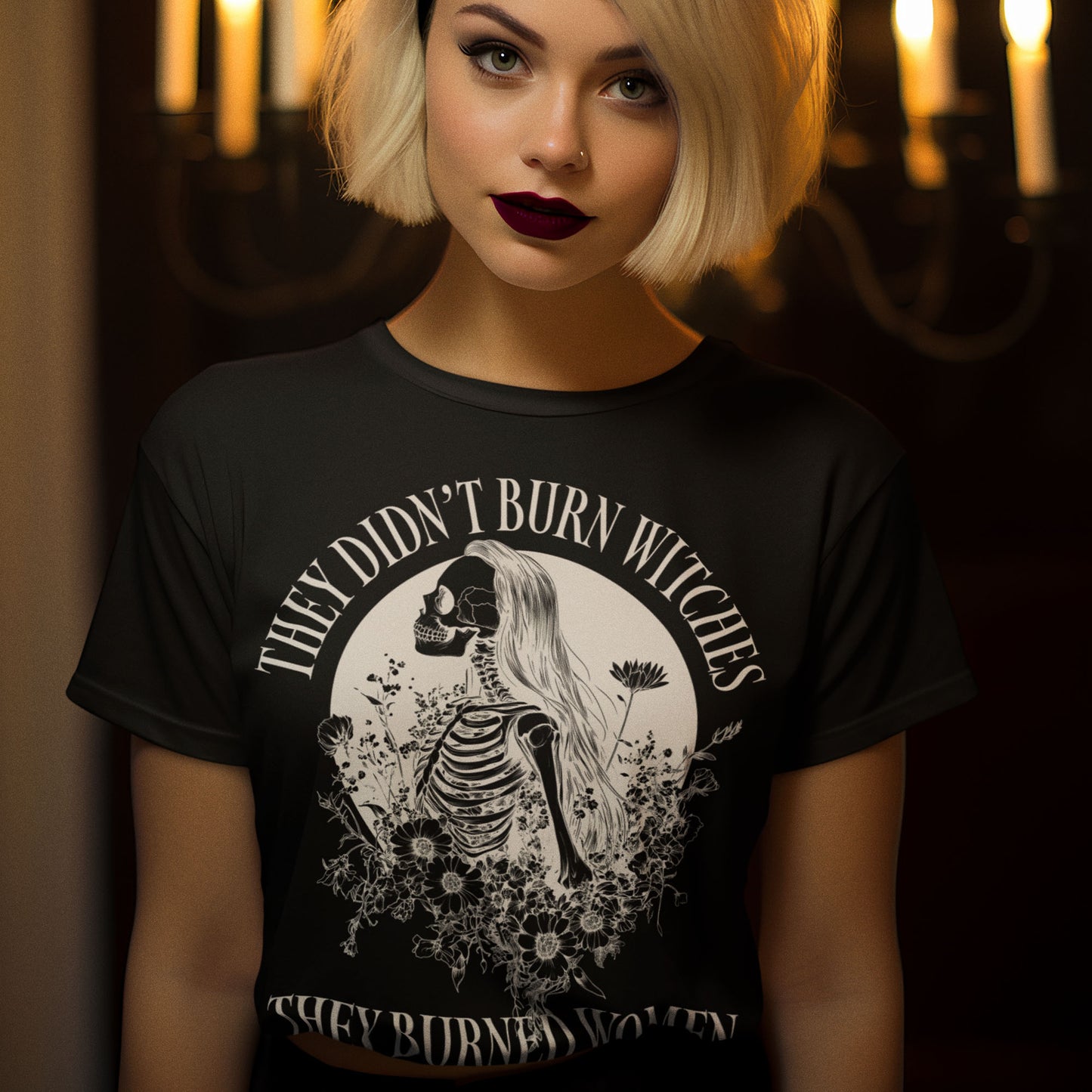 Person wearing the They Didn’t Burn Witches They Burned Women Feminist Liberal Witch with a skeleton design and text in a dimly lit setting.