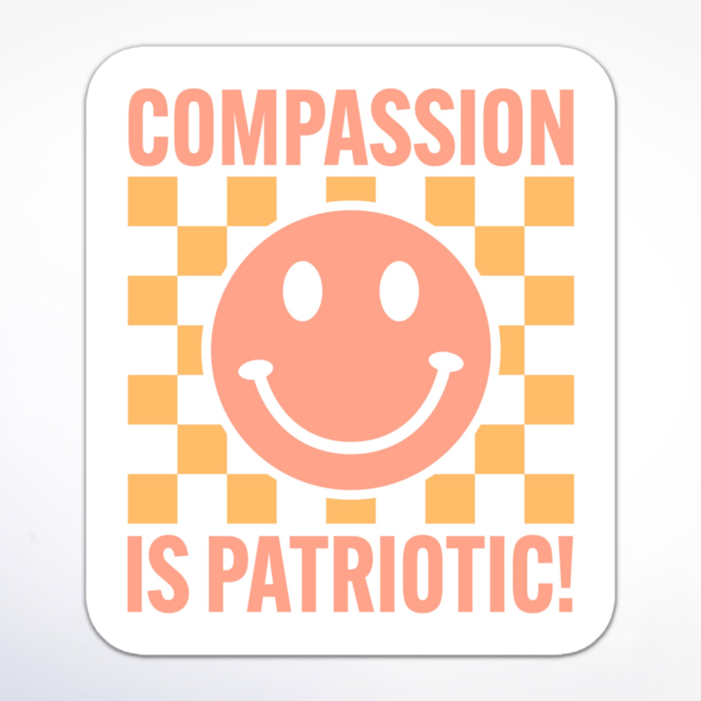 Minimalist social justice sticker featuring a smiley face and block text “Compassion is Patriotic!” in an orange gradient on a whitet background.