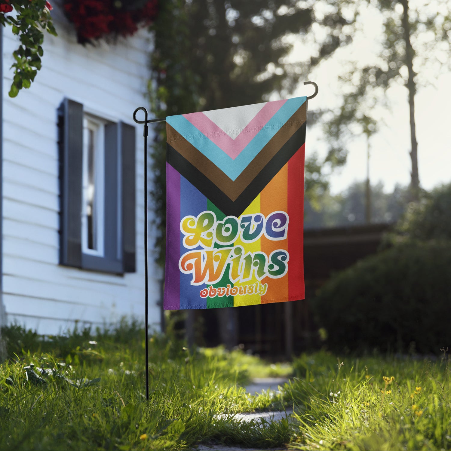 "Love Wins Obviously" Progress Pride Garden Flag in the garden. Great for LGBTQ+ Ally.