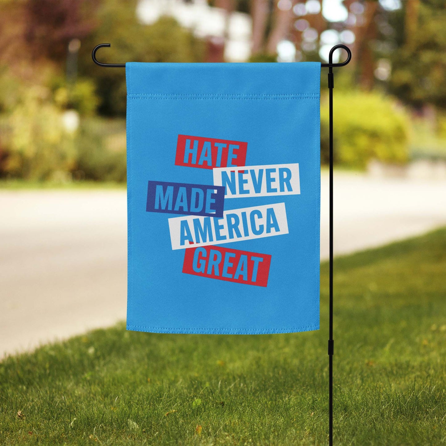 Front View Image: Full display of the Hate Never Made America Great garden flag in a yard.