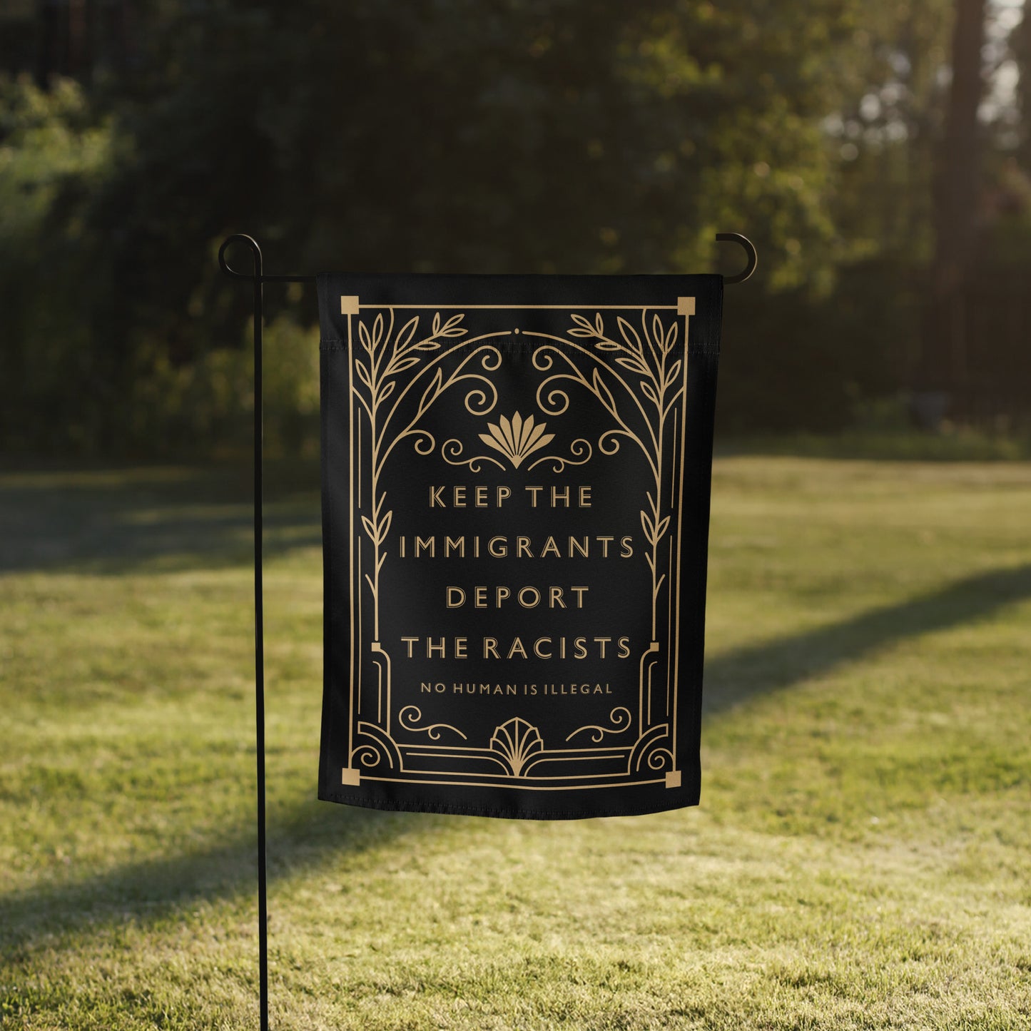 Front View Image: Keep The Immigrants Deport The Racists Art Deco Garden Flag displayed outdoors on stand