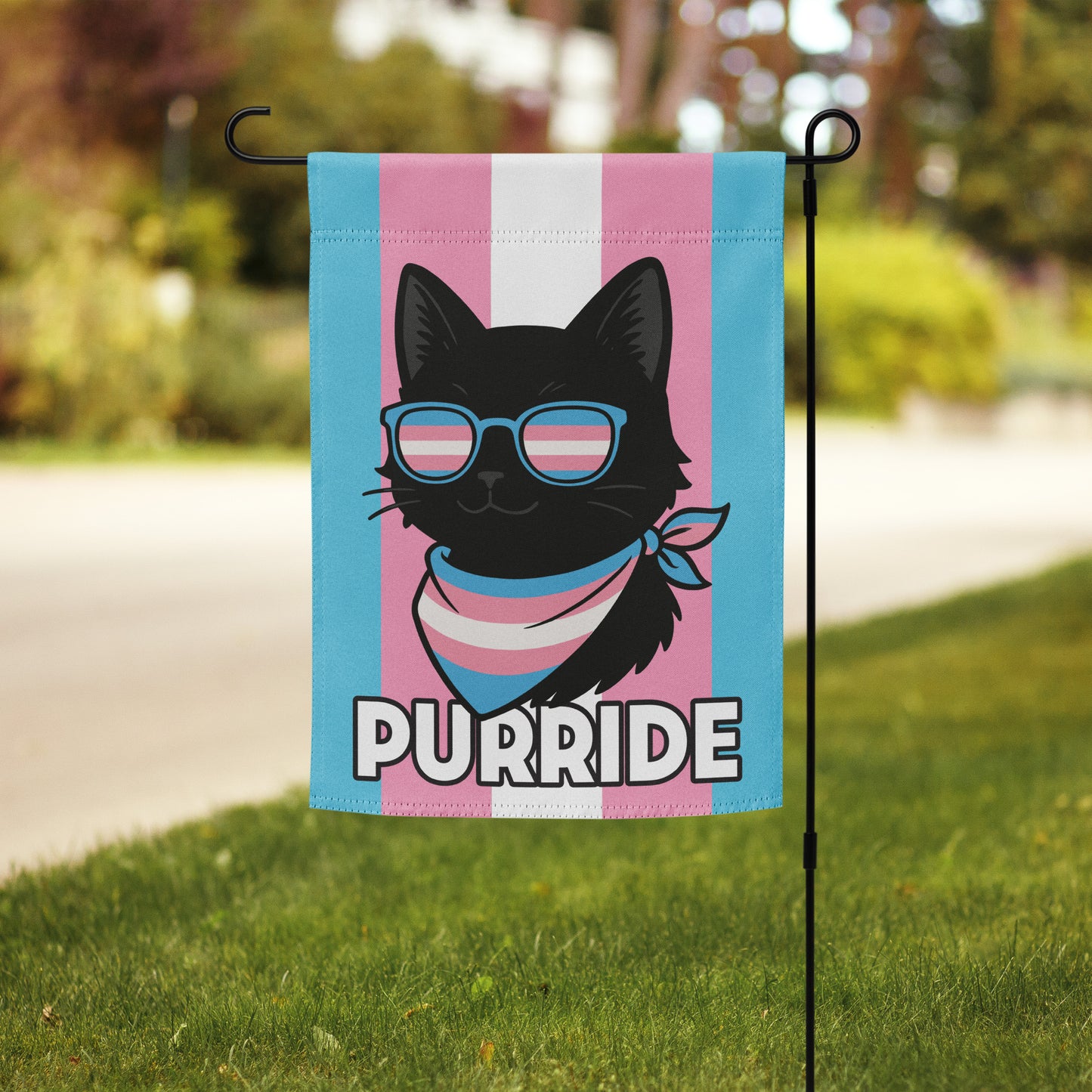 “Purride” cat garden flag with transgender pride colors shown on a flag stand in a front yard setting.