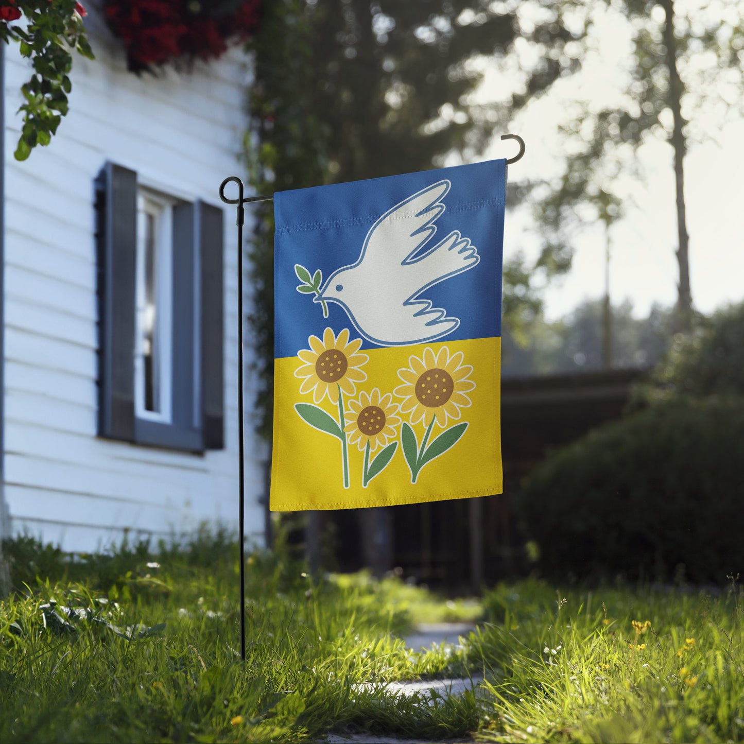 Progressive Ukraine Solidarity garden flag with dove and sunflower design, shown outdoors in front of a house.
