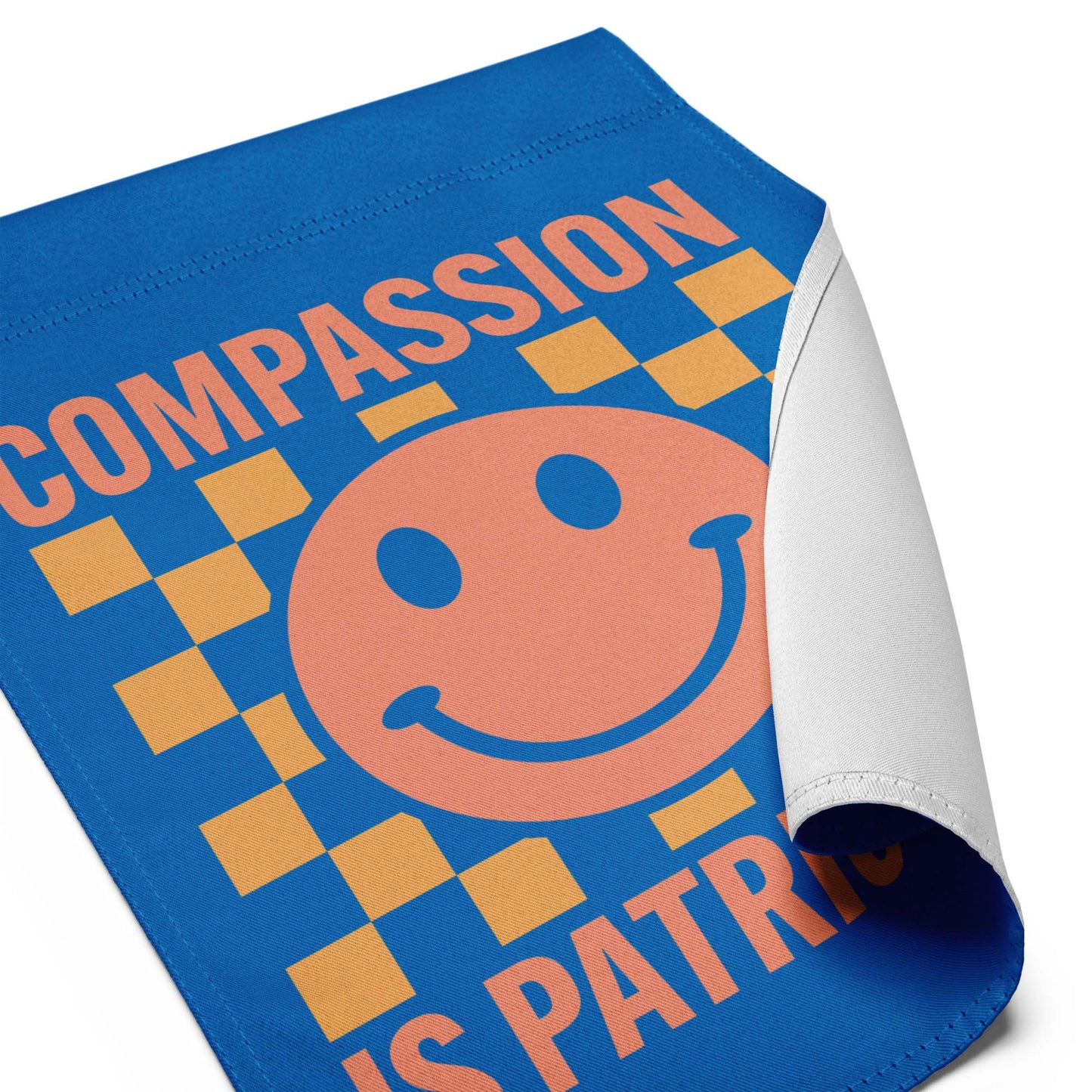 Detail view: Compassion Is Patriotic! Social Justice Patriotic Kindness progressive garden flag displayed in a white background