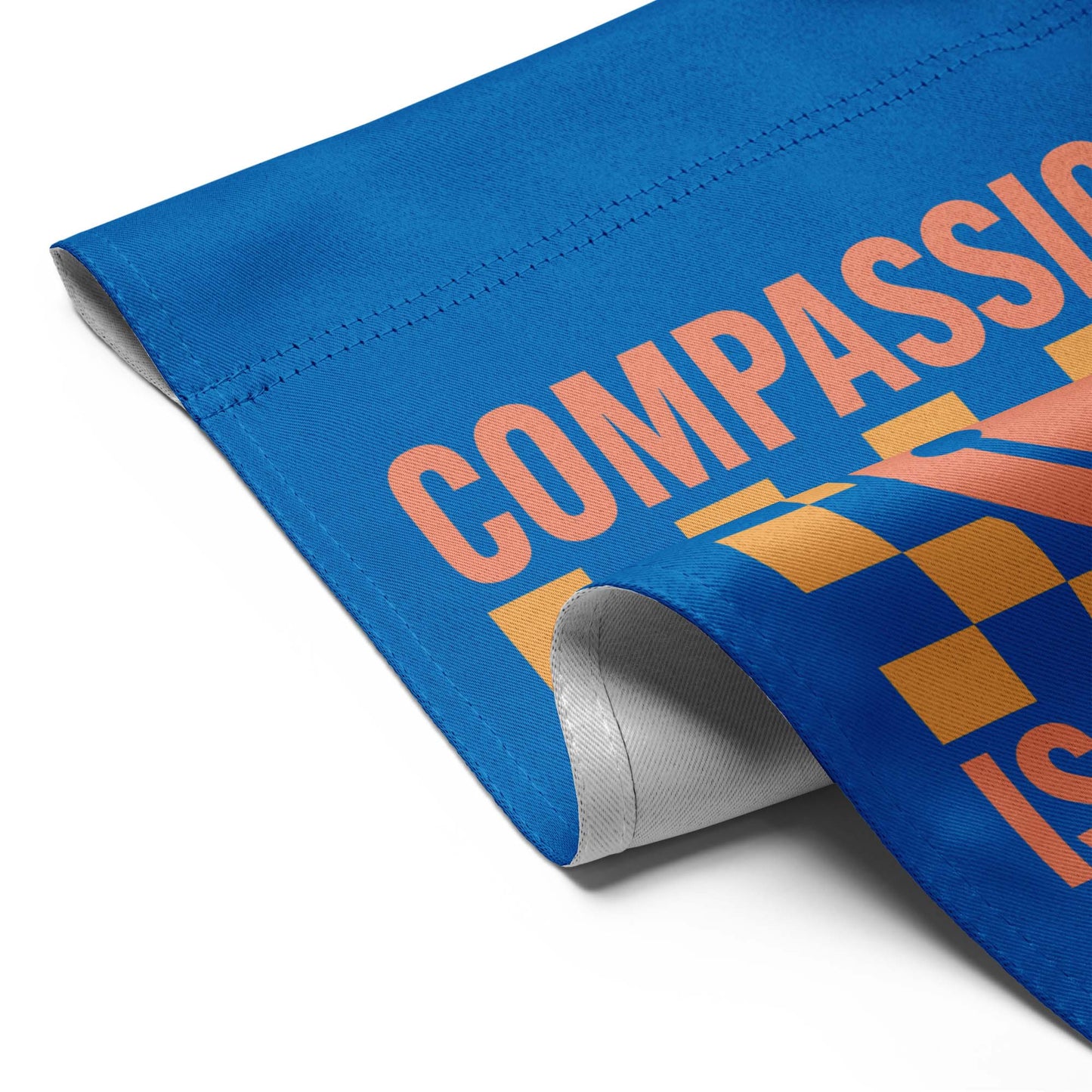 Detail view: Compassion Is Patriotic! Social Justice Patriotic Kindness progressive garden flag displayed in a white background