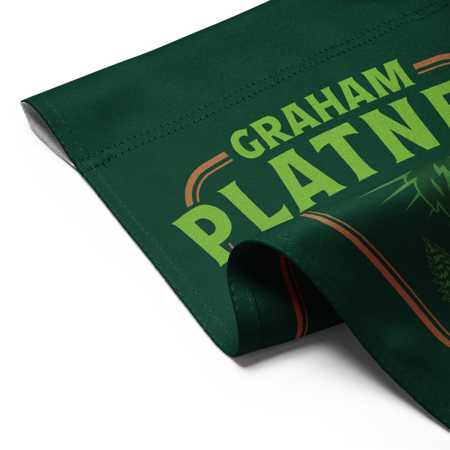 Folded green garden flag displaying partial moose graphic and “Graham Platner Maine Standard” text in rustic Maine-inspired design.