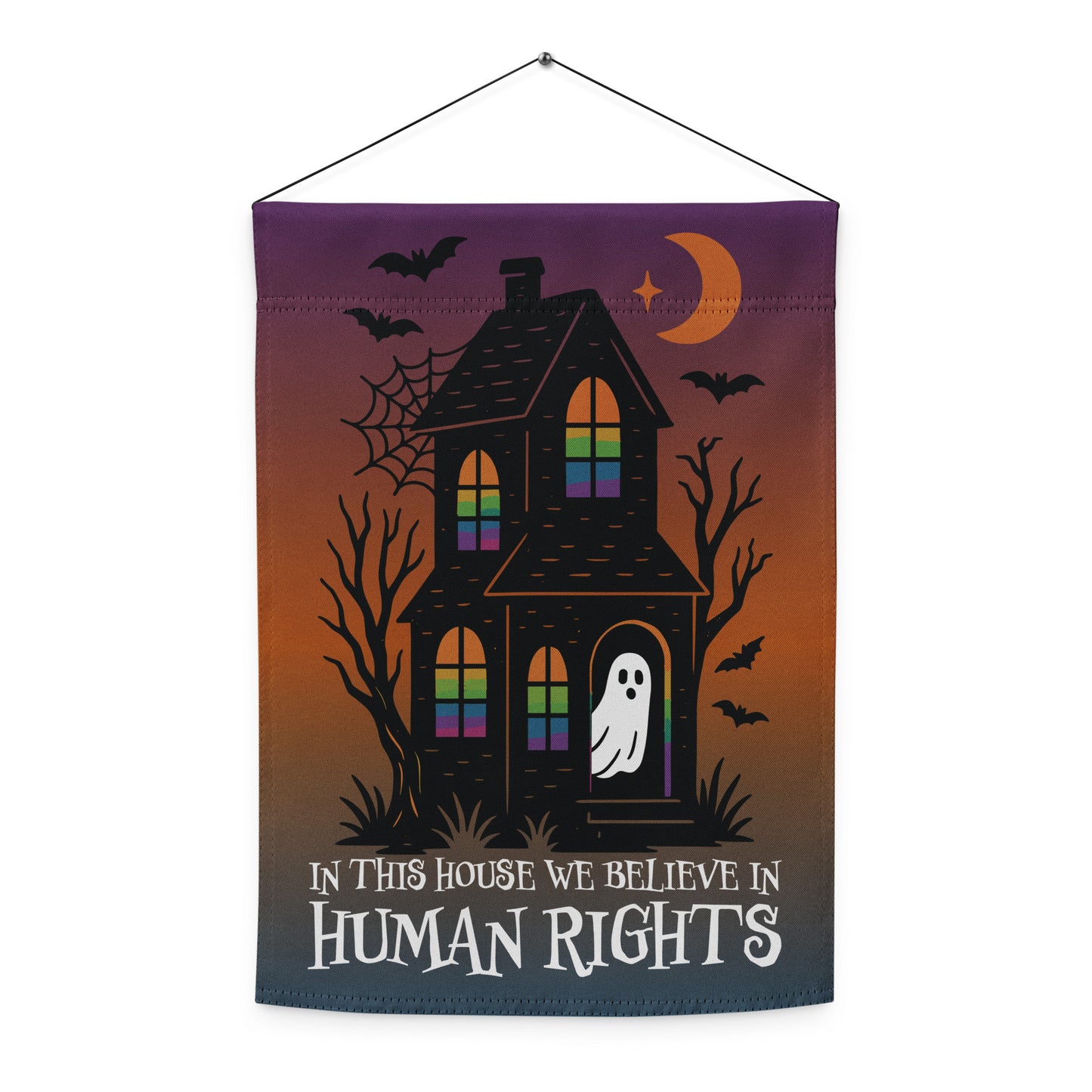 Front view of the “In This House We Believe in Human Rights” haunted house garden flag with bats, crescent moon, and ghost.
