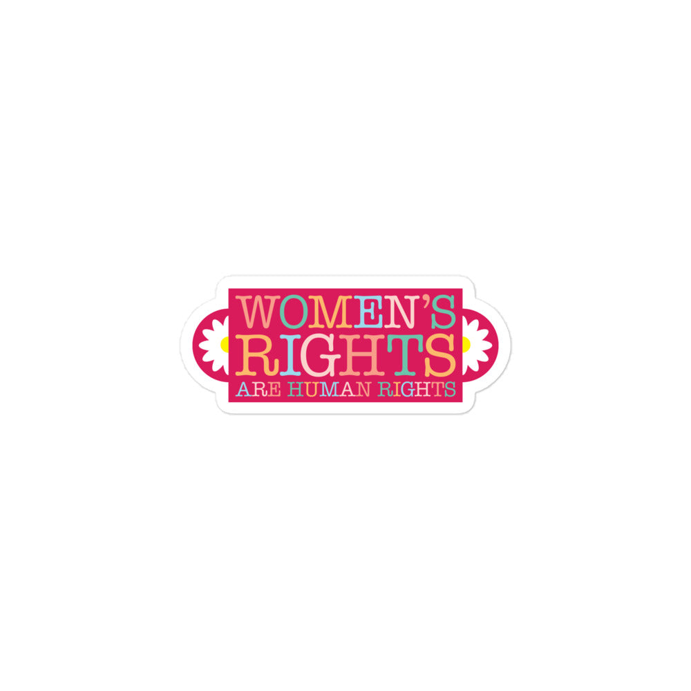 Sticker shown at smaller scale featuring vintage-style lettering in pink and gold tones with floral details, symmetrical design, printed message “WOMEN’S RIGHTS ARE HUMAN RIGHTS,” feminist sticker from Blue Wave USA.