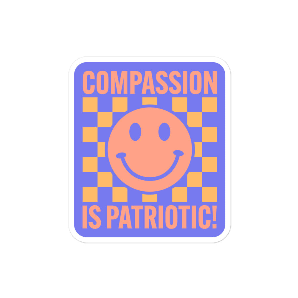 Close-up of the smiley face and text Compassion Is Patriotic on the sticker.