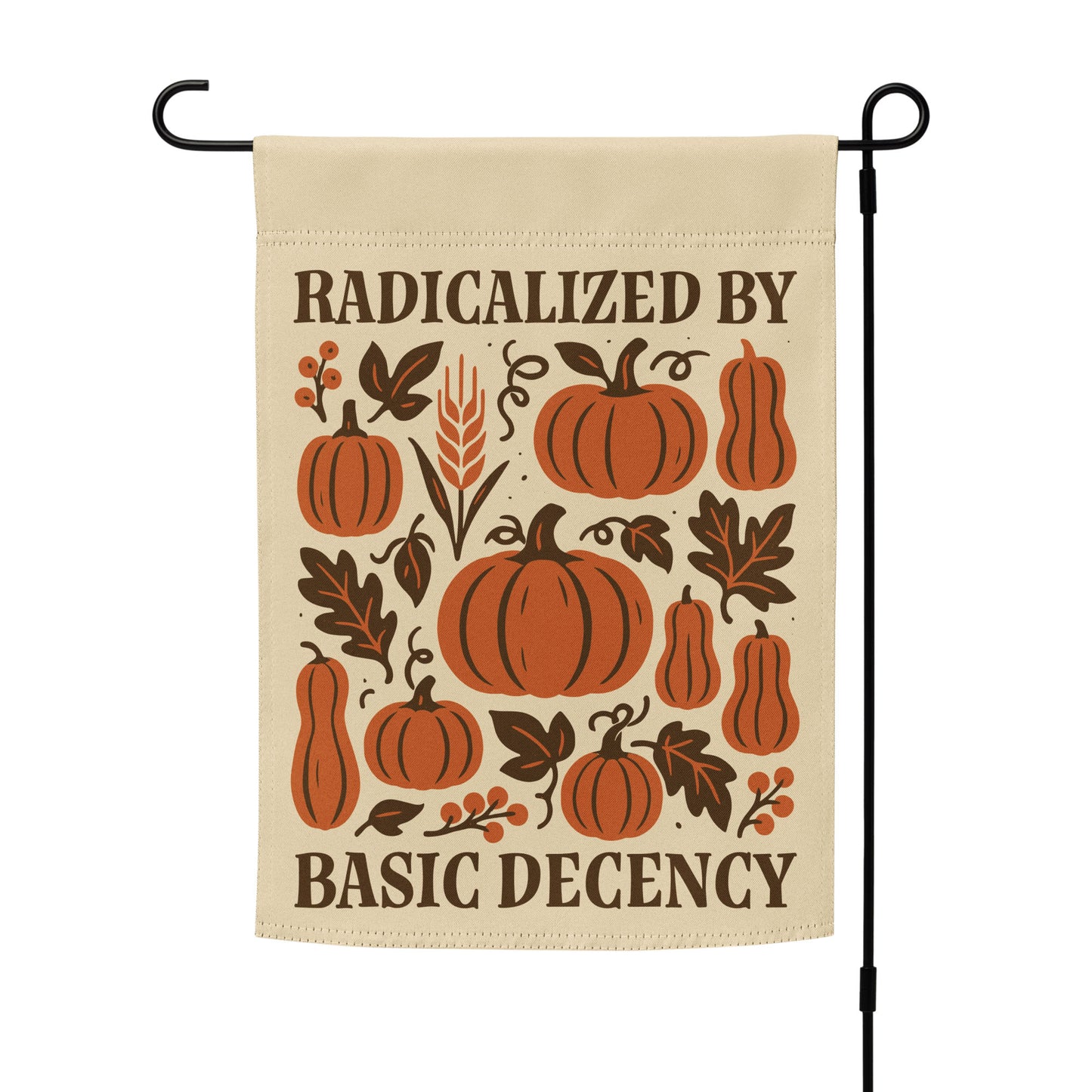 “Radicalized By Basic Decency” progressive garden flag with autumn pumpkin design, displayed on a stand outdoors.