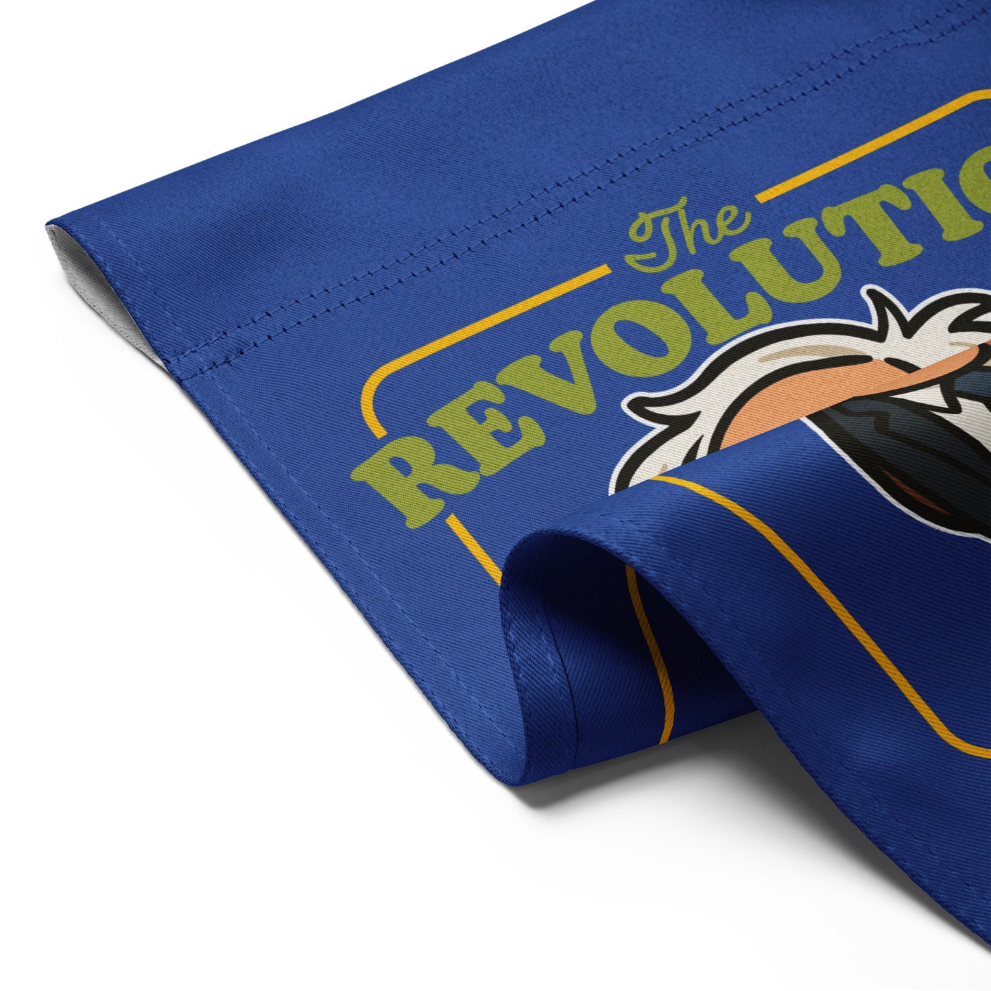 Folded royal blue garden flag displaying partial revolution typography and Birdie Sanders artwork in bold progressive outdoor decor design.