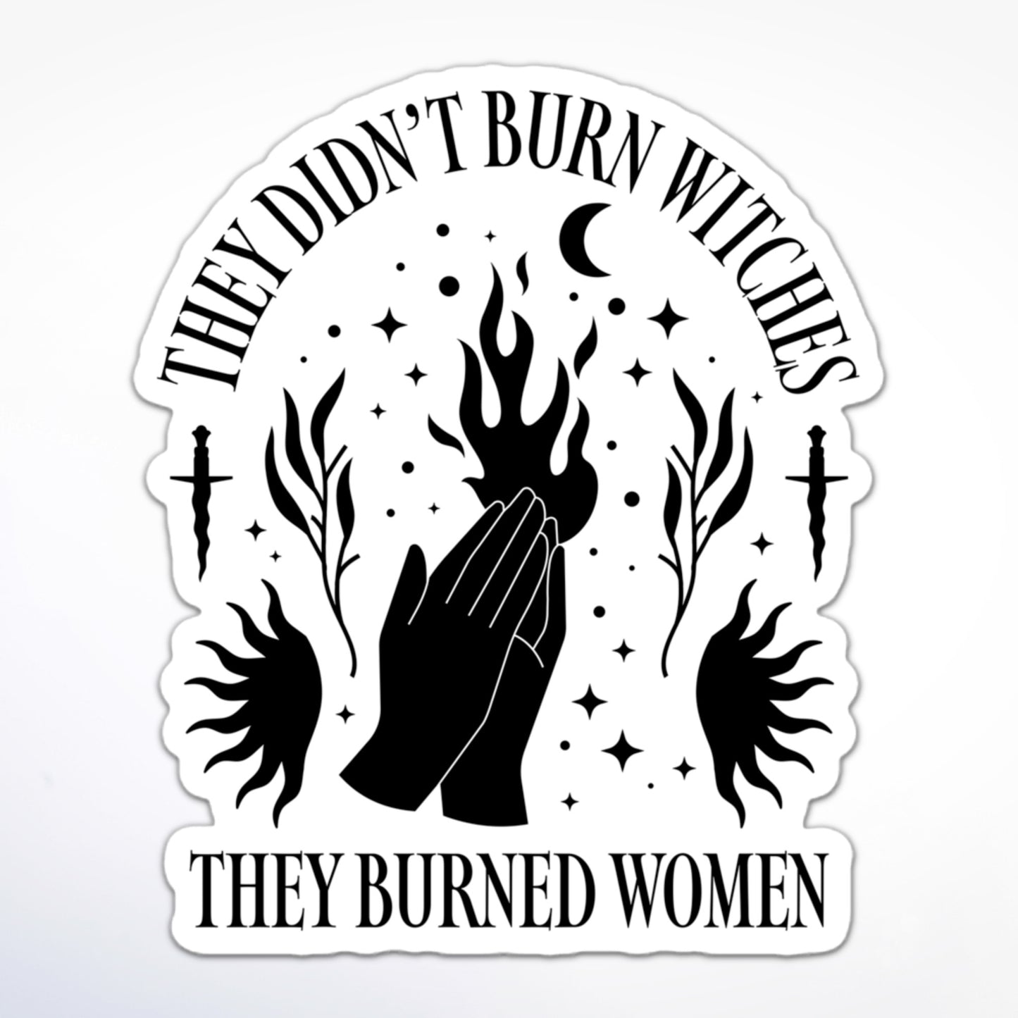 Feminist sticker with witchy iconography—hands, fire, moon, and daggers—paired with “They Didn’t Burn Witches, They Burned Women.”