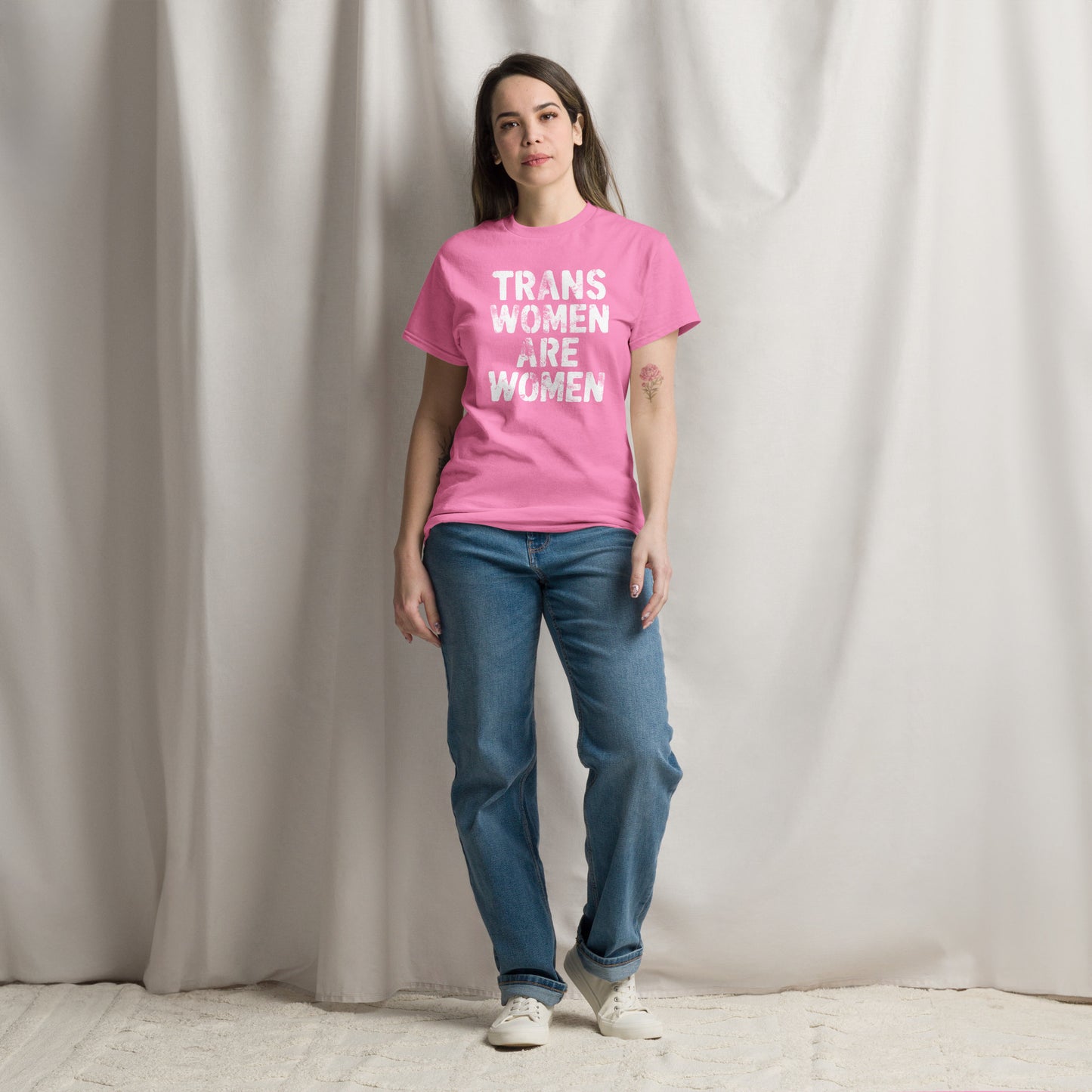 Female trans rights advocate wearing the pink "Trans Women Are Women" Trans Rights Distressed Tee