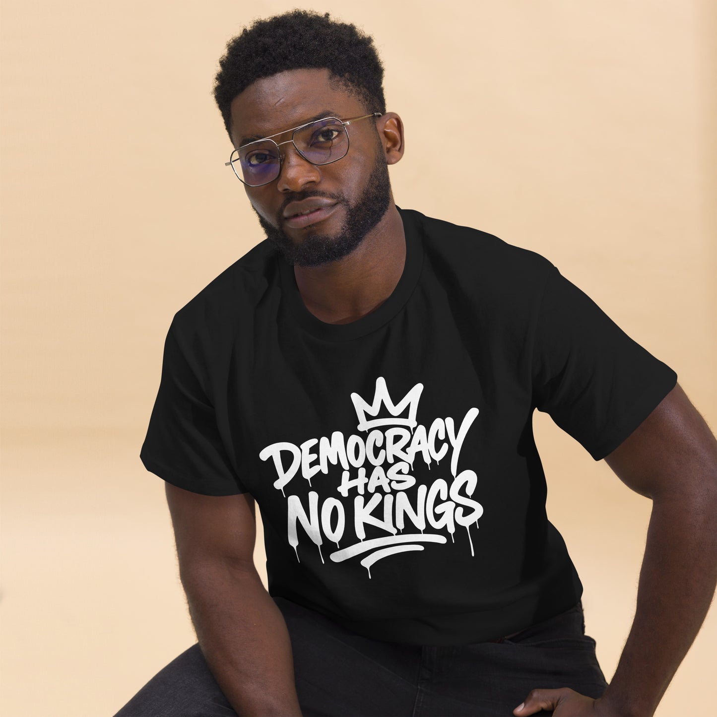 Lifestyle Image: Black Man Activist wearing Democracy Has No Kings shirt at rally