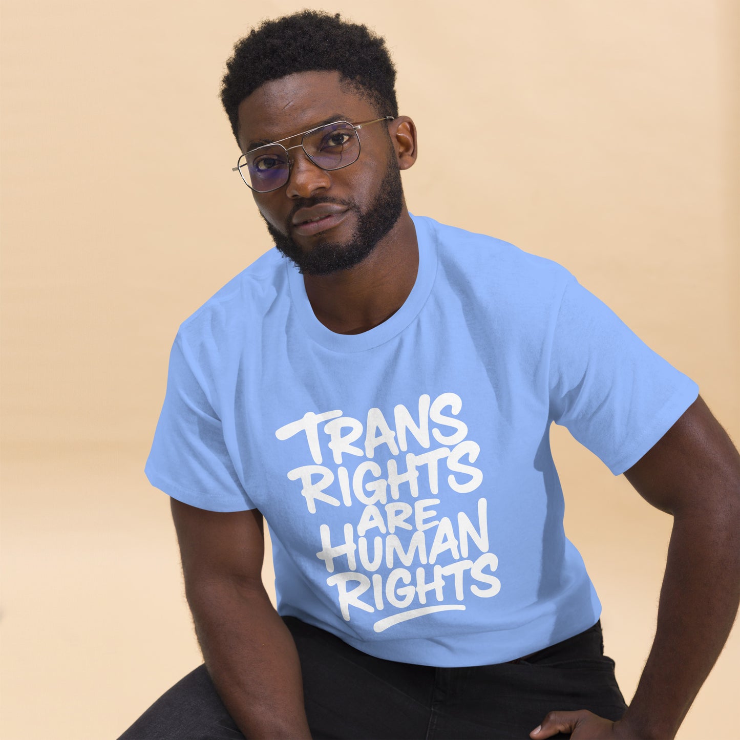 Black Male Trans Rights Activist wearing the "Trans Rights Are Human Rights" LGBTQ+ Activism Unisex Classic Tee