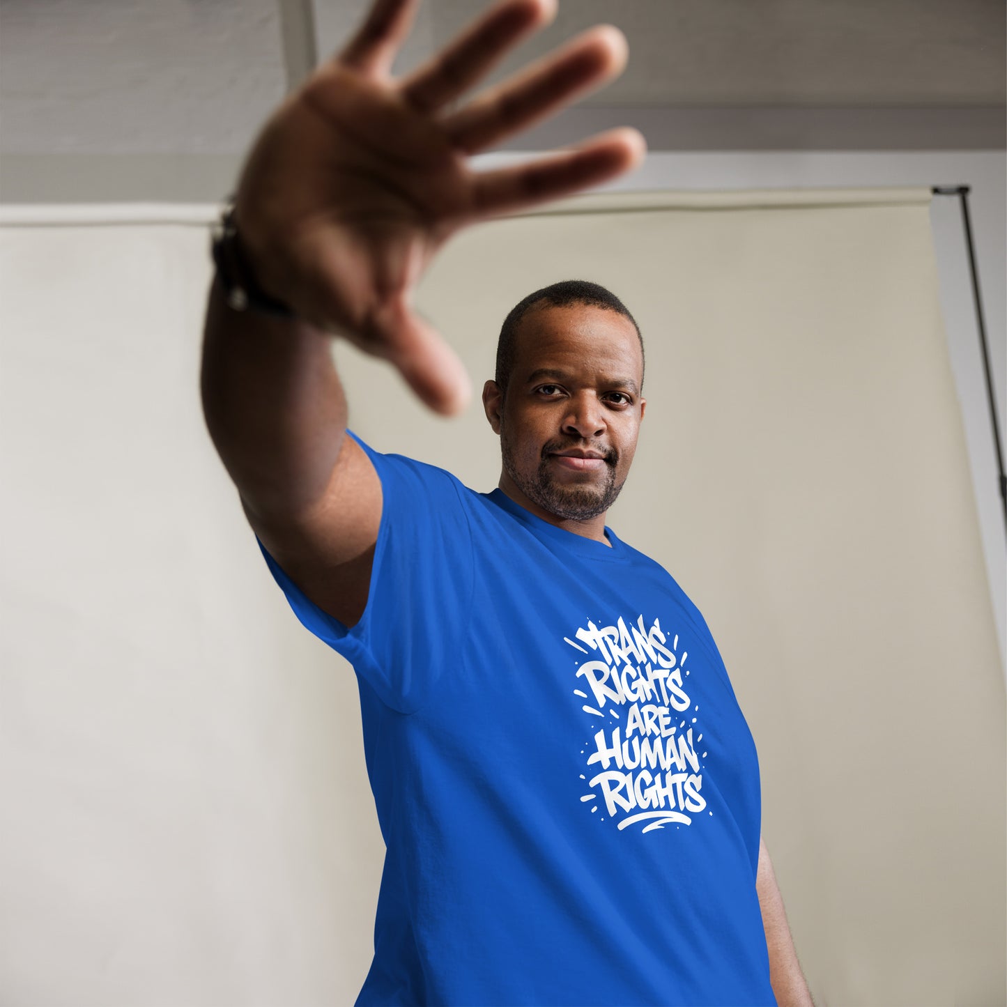 Black male activist wearing the "Trans Rights Are Human Rights" LGBTQ+ Activist Slogan Unisex Classic Tee