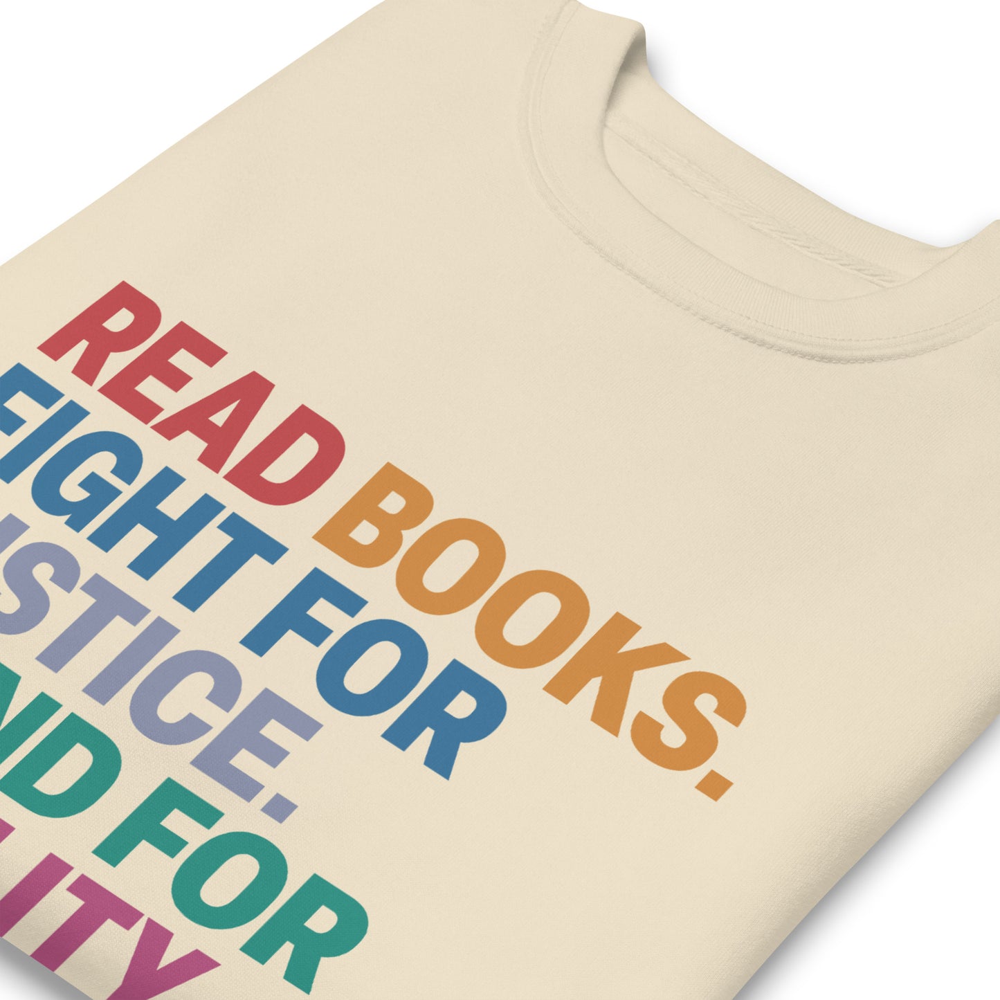 Close-up of impactful social justice slogan printed on sweatshirt with “Read Books. Fight For Justice. Stand For Equality. Protect The Vulnerable.” text.