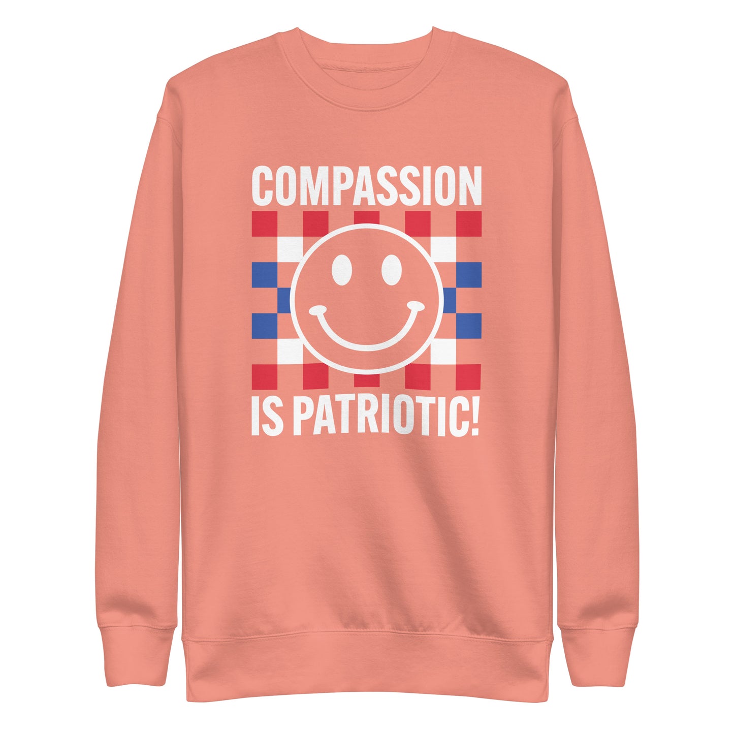 Front view of the Compassion Is Patriotic Premium Unisex Sweatshirt in red, white, and blue featuring a smiley face and bold text.