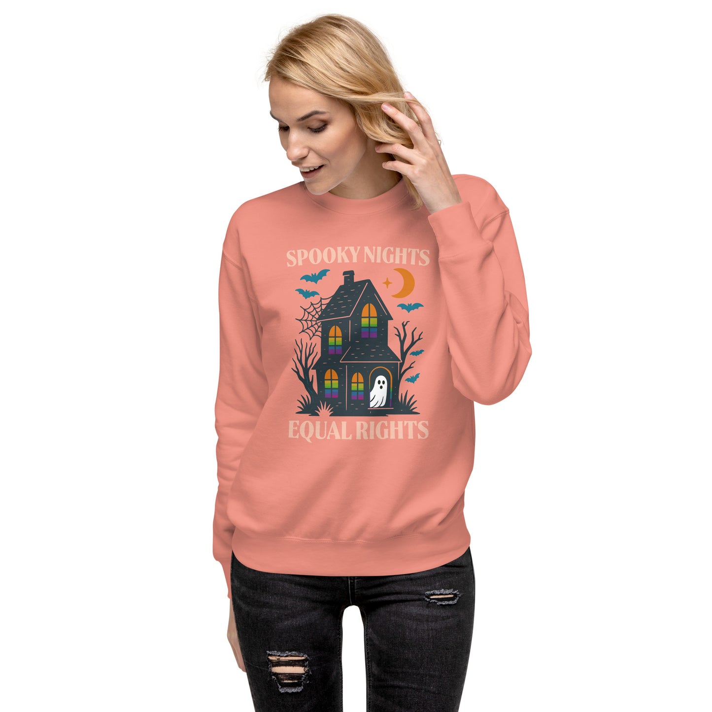 Model wearing dusty rose “Spooky Nights, Equal Rights” Halloween sweatshirt with haunted house graphic, Blue Wave USA progressive apparel for fall.