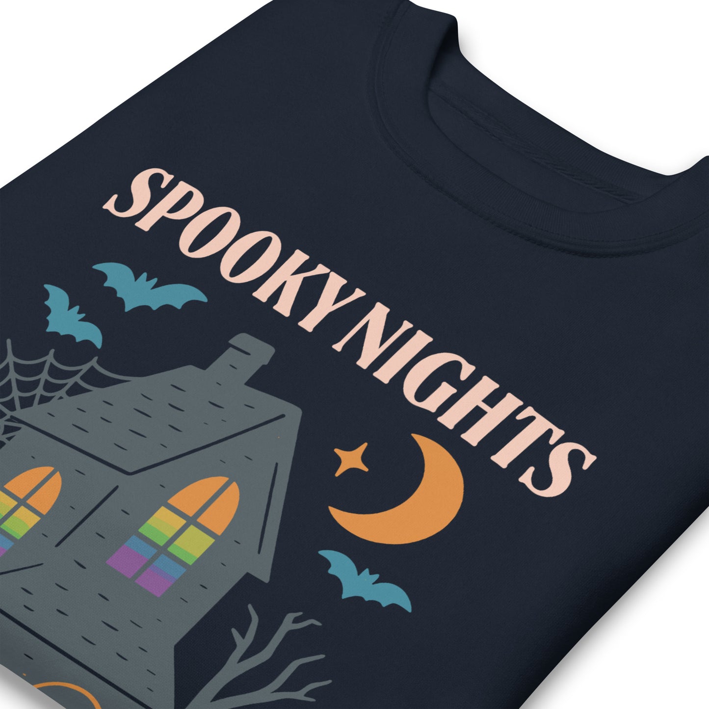 Close-up of “Spooky Nights, Equal Rights” haunted house and moon print on navy sweatshirt, Halloween feminist activist design.