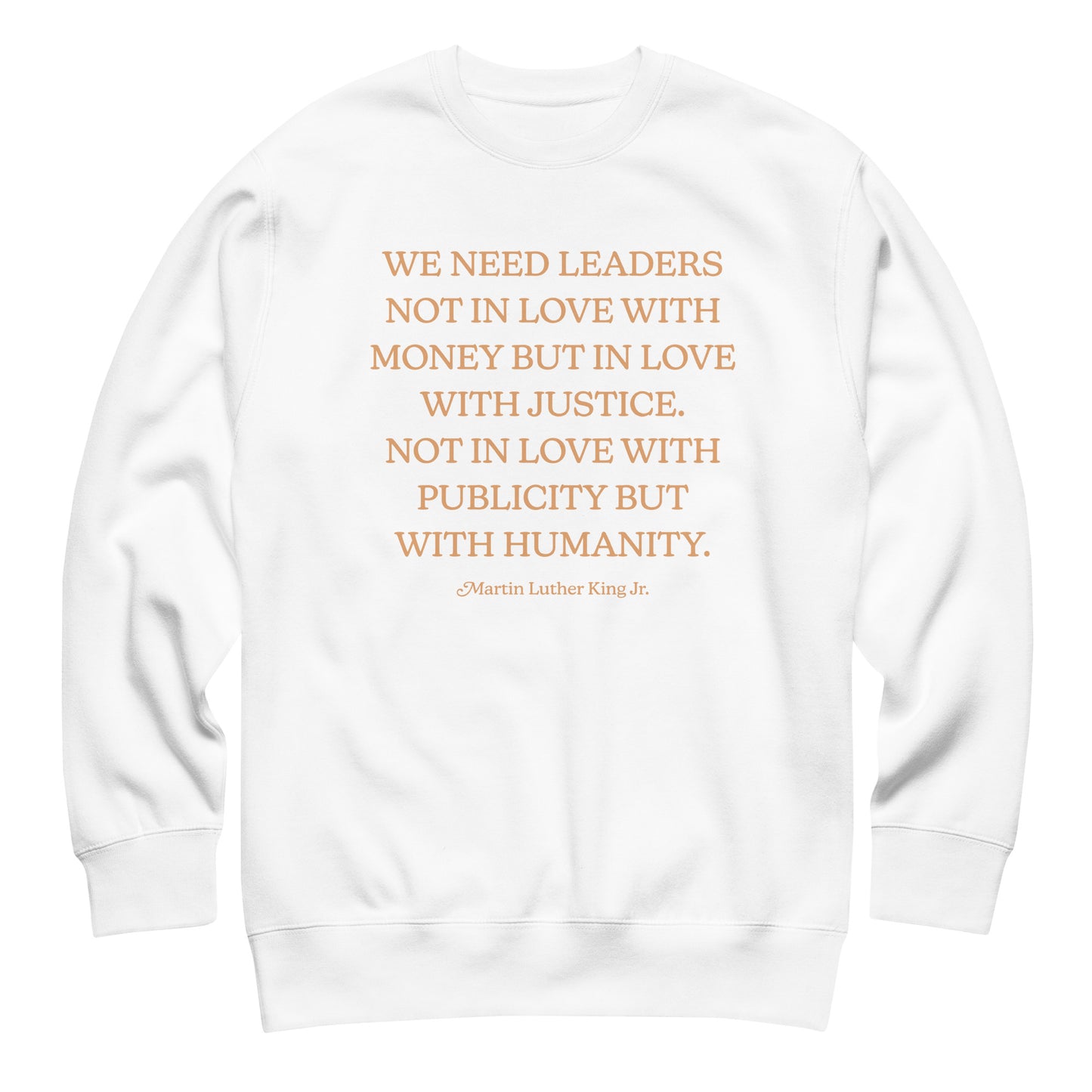 White unisex premium sweatshirt with the full MLK quote arranged in gold text, promoting justice-driven leadership and public compassion.
