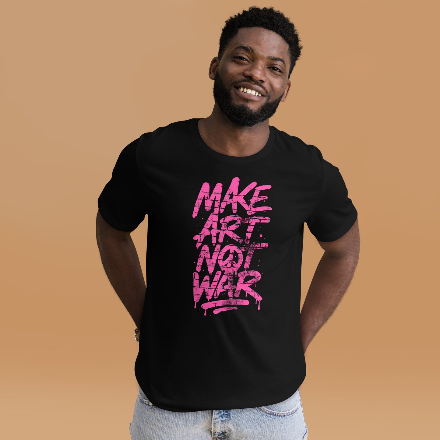 Black male protester wearing the Make Art Not War graffiti protest t-shirt with bold pink spray-paint lettering