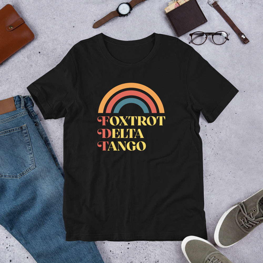 Flat lay of the T-shirt highlighting the retro rainbow and anti-Trump message.