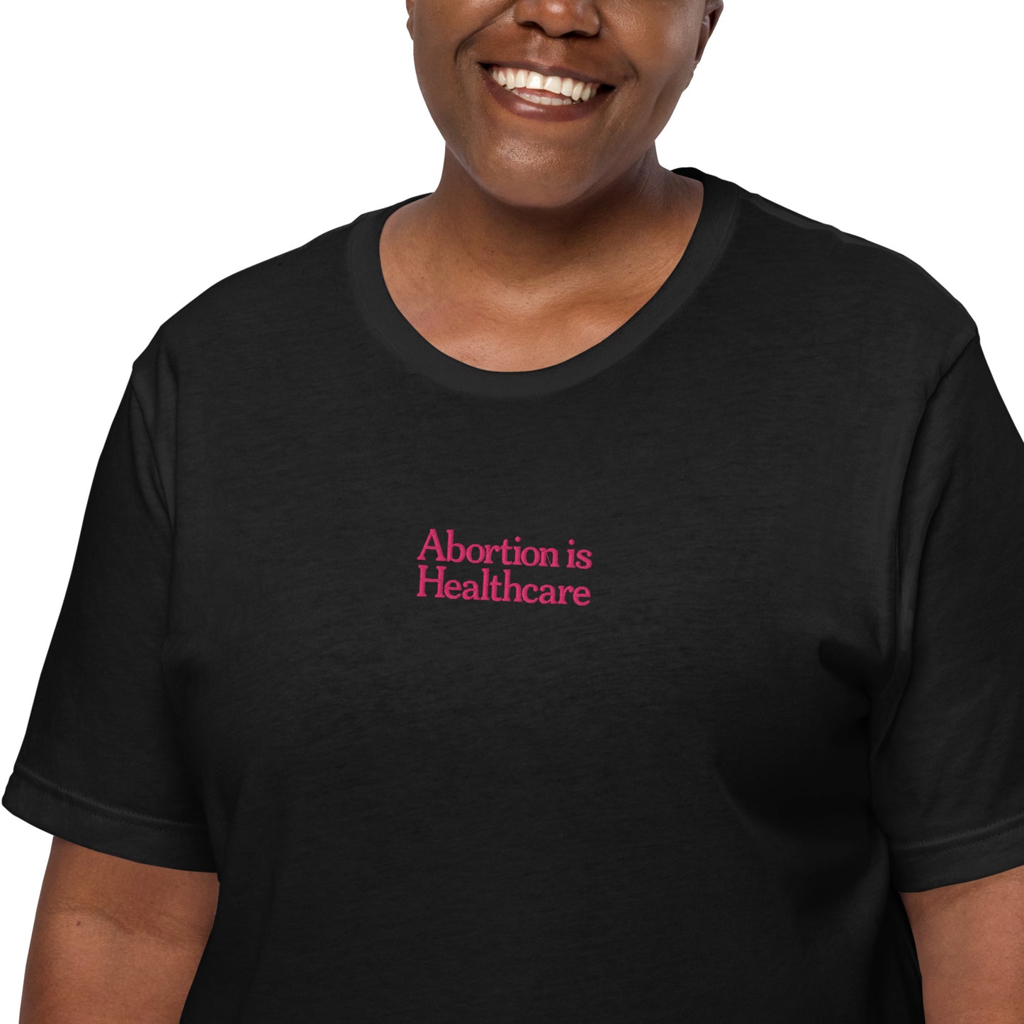 Black woman wearing the"Abortion Is Healthcare" Reproductive Rights Embroidered Unisex T-Shirt