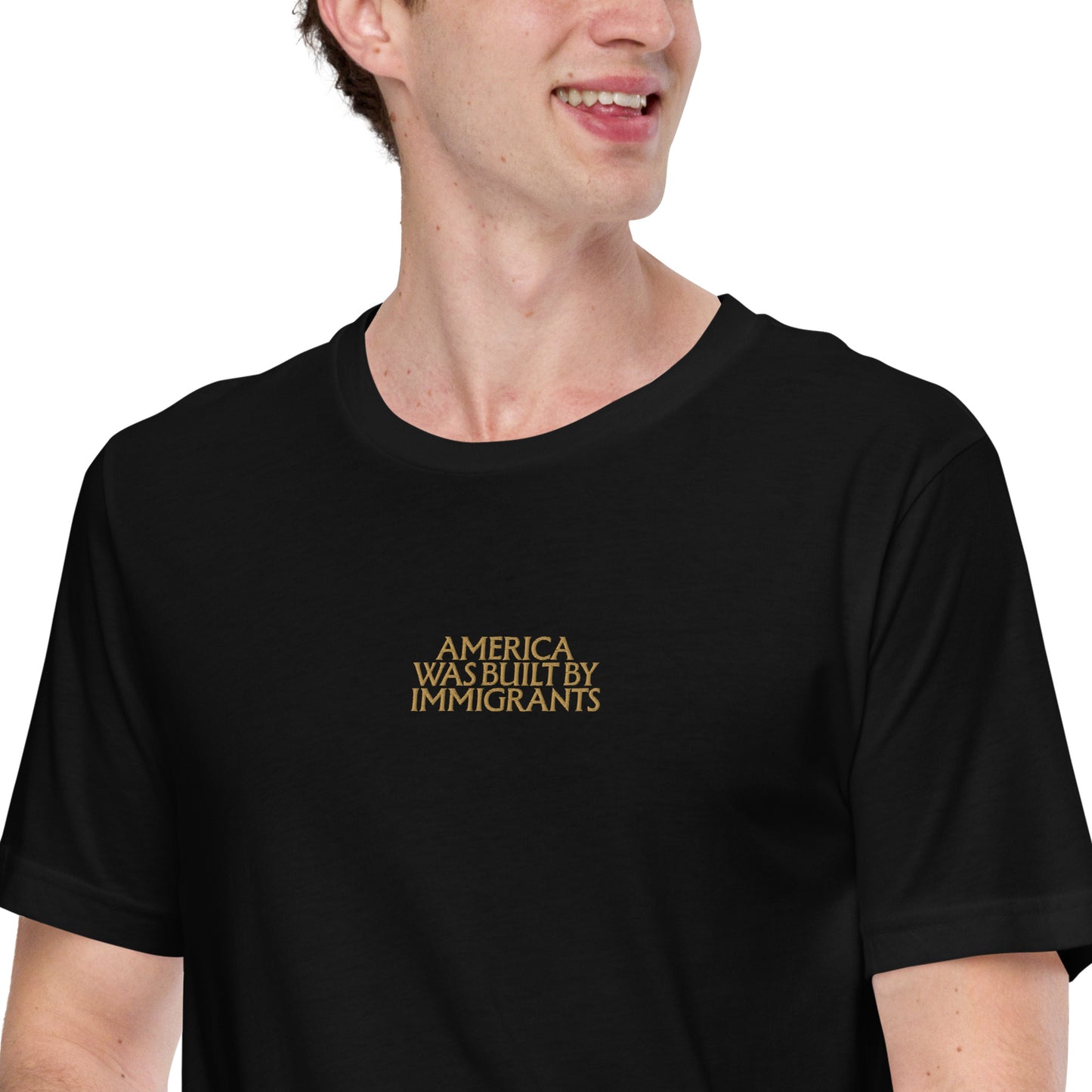 Man wearing the "America Was Built By Immigrants" Pro-Immigrant Embroidered Unisex T-Shirt