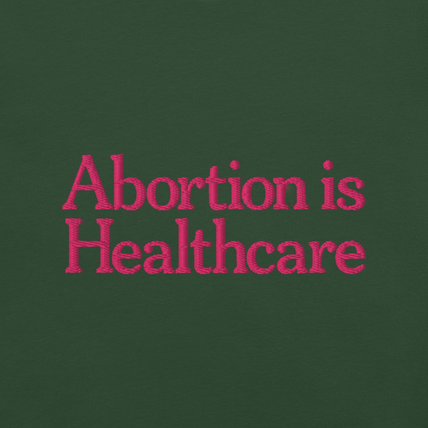 Detail view of the"Abortion Is Healthcare" Reproductive Rights Embroidered Unisex T-Shirt