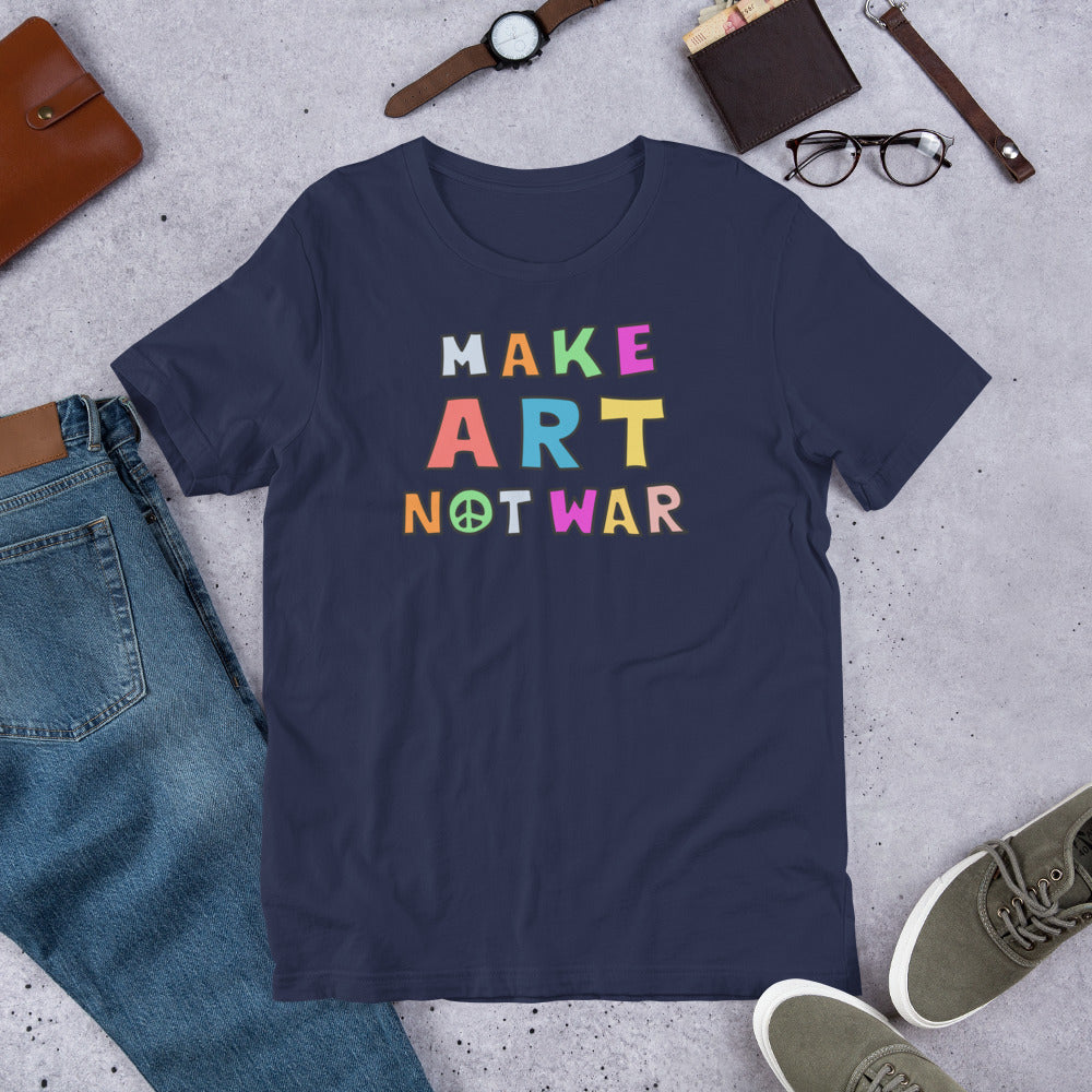 Flat Lay Image: Flat lay of the Make Art Not War unisex anti-war graphic tee, styled with casual wear items