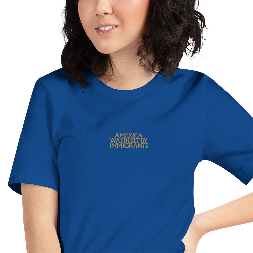 Woman wearing the "America Was Built By Immigrants" Pro-Immigrant Embroidered Unisex T-Shirt