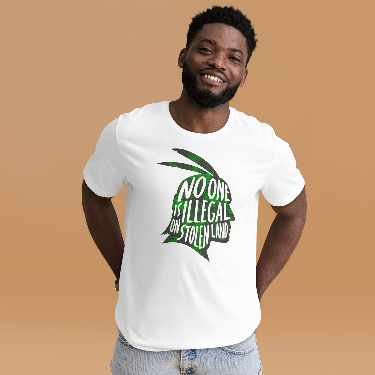 Lifestyle Image: Black male advocate wearing the No One Is Illegal On Stolen Land Graphic Unisex Tee
