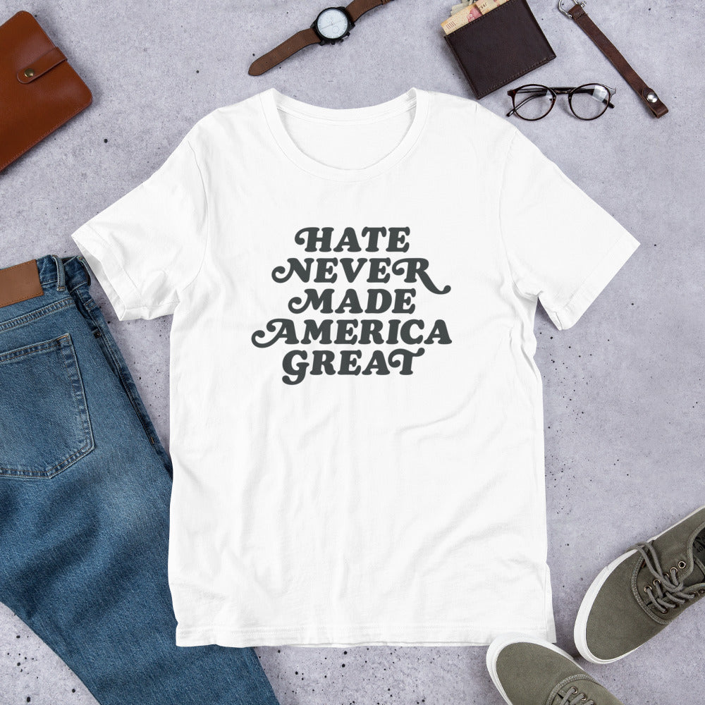 Flat lay of Hate Never Made America Great T-Shirt styled with everyday accessories.