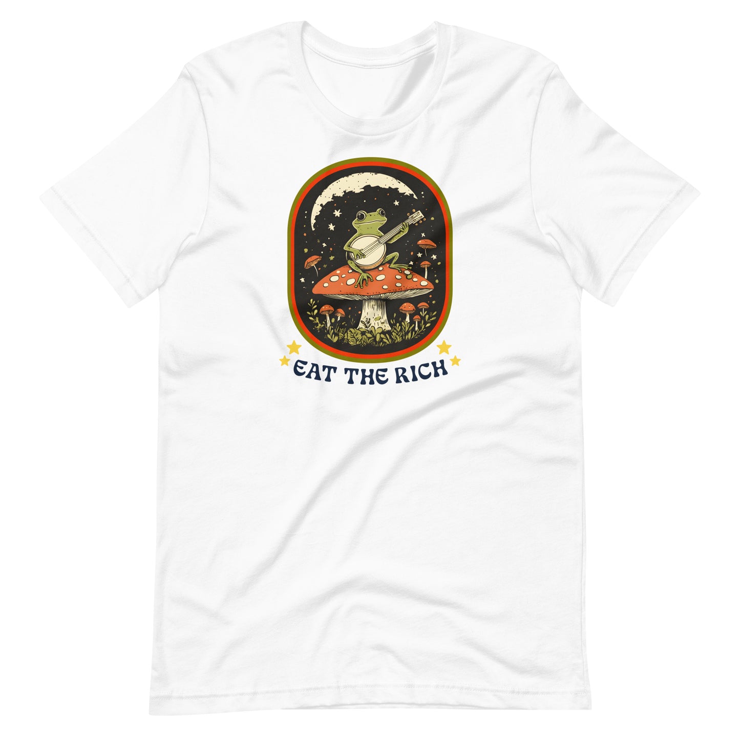 White t-shirt featuring a retro frog-and-banjo illustration with decorative stars and bold “Eat The Rich” slogan in a vintage-inspired frame.